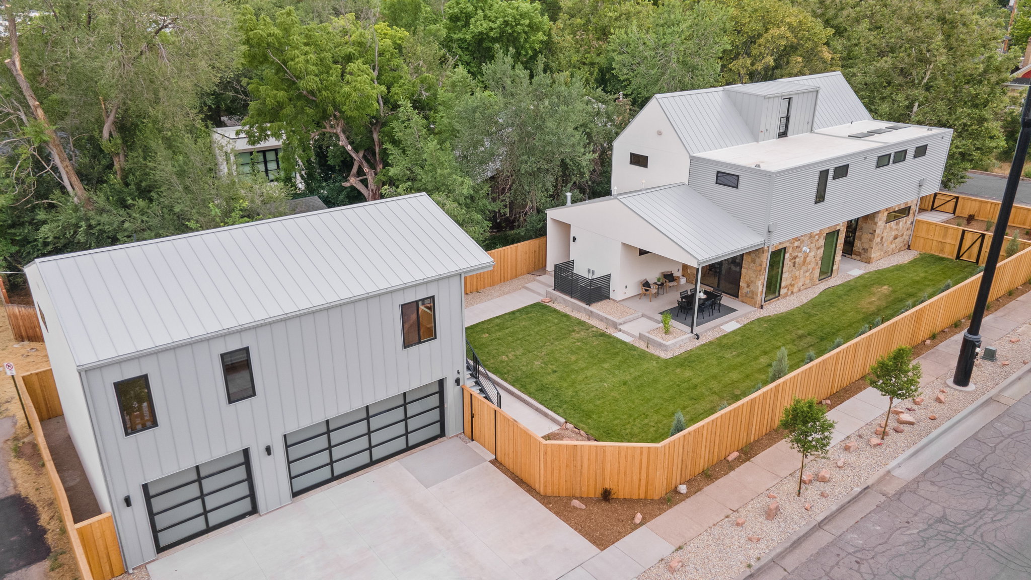 Modern architectural design with a detached garage featuring two glass-paneled doors