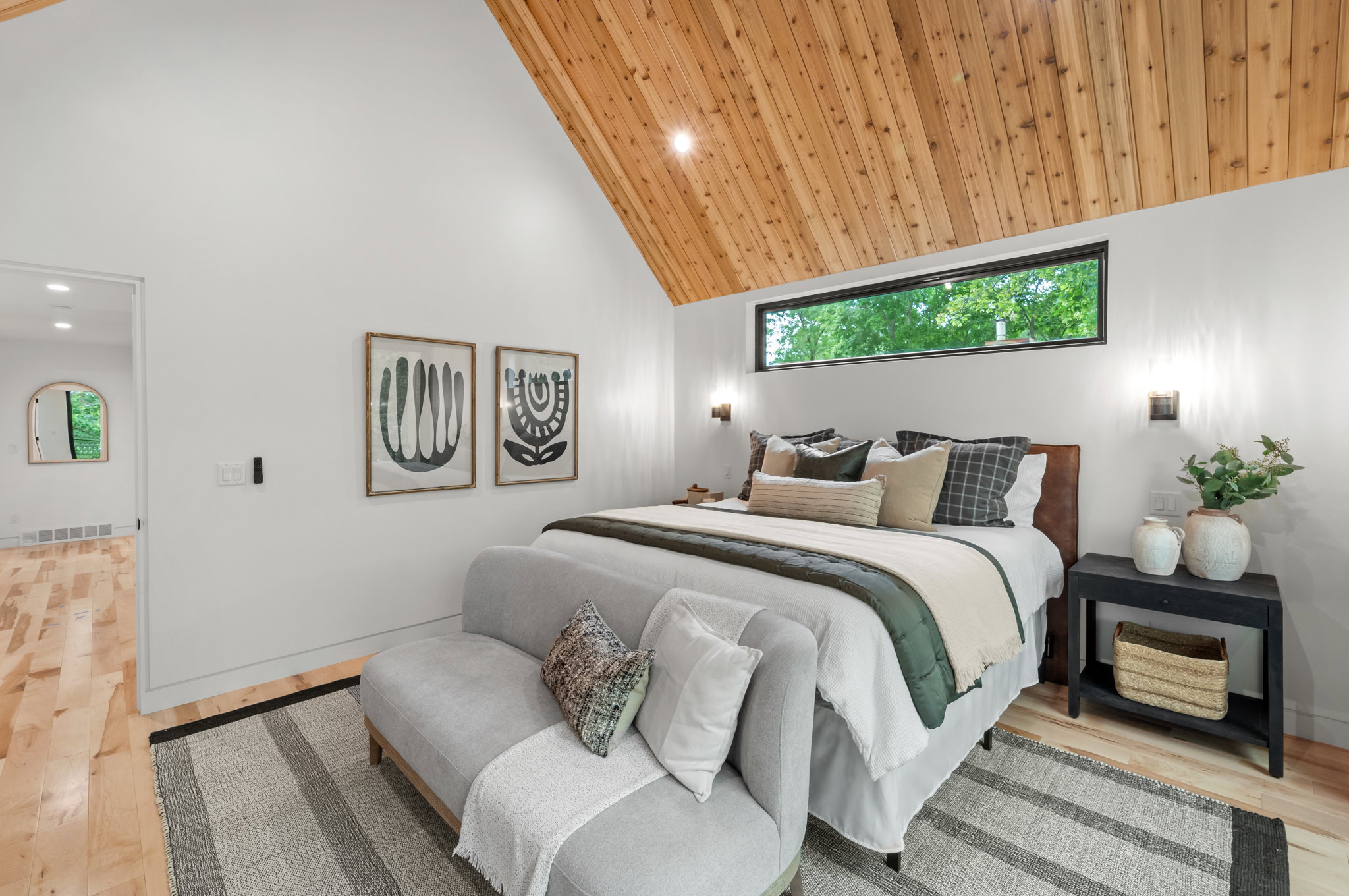 Vaulted wood-paneled ceiling with a horizontal window