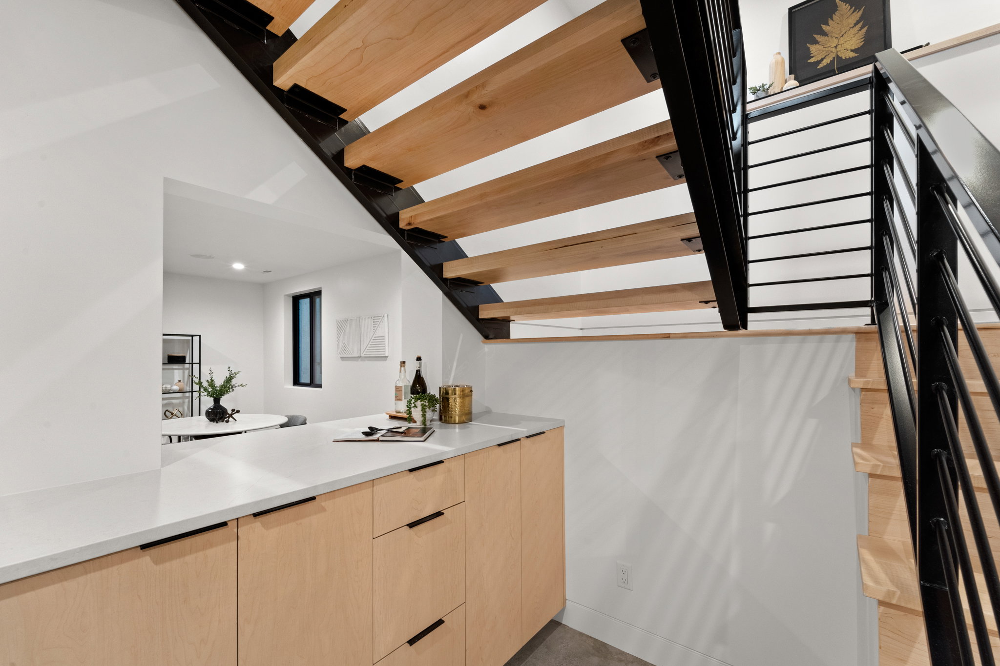Modern open-riser staircase with wood treads and black metal railings