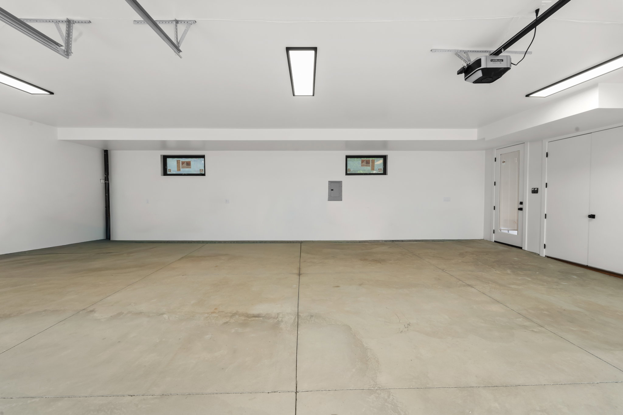 Spacious garage with exposed concrete flooring