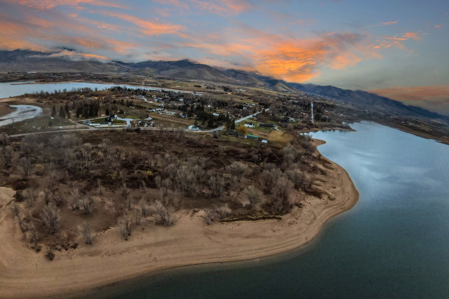 Expansive waterfront property featuring a sandy shoreline and direct access to the lake