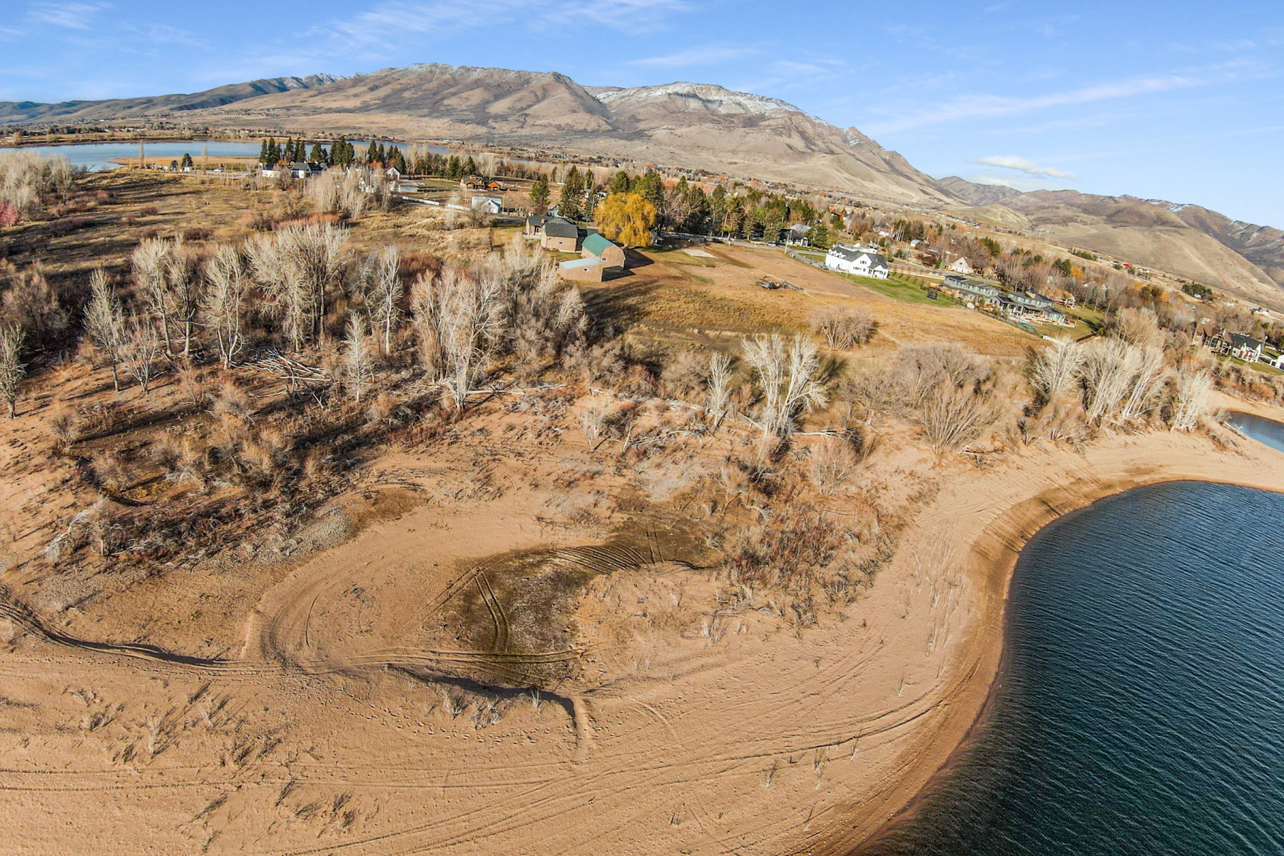 Expansive waterfront property featuring a substantial sandy shoreline