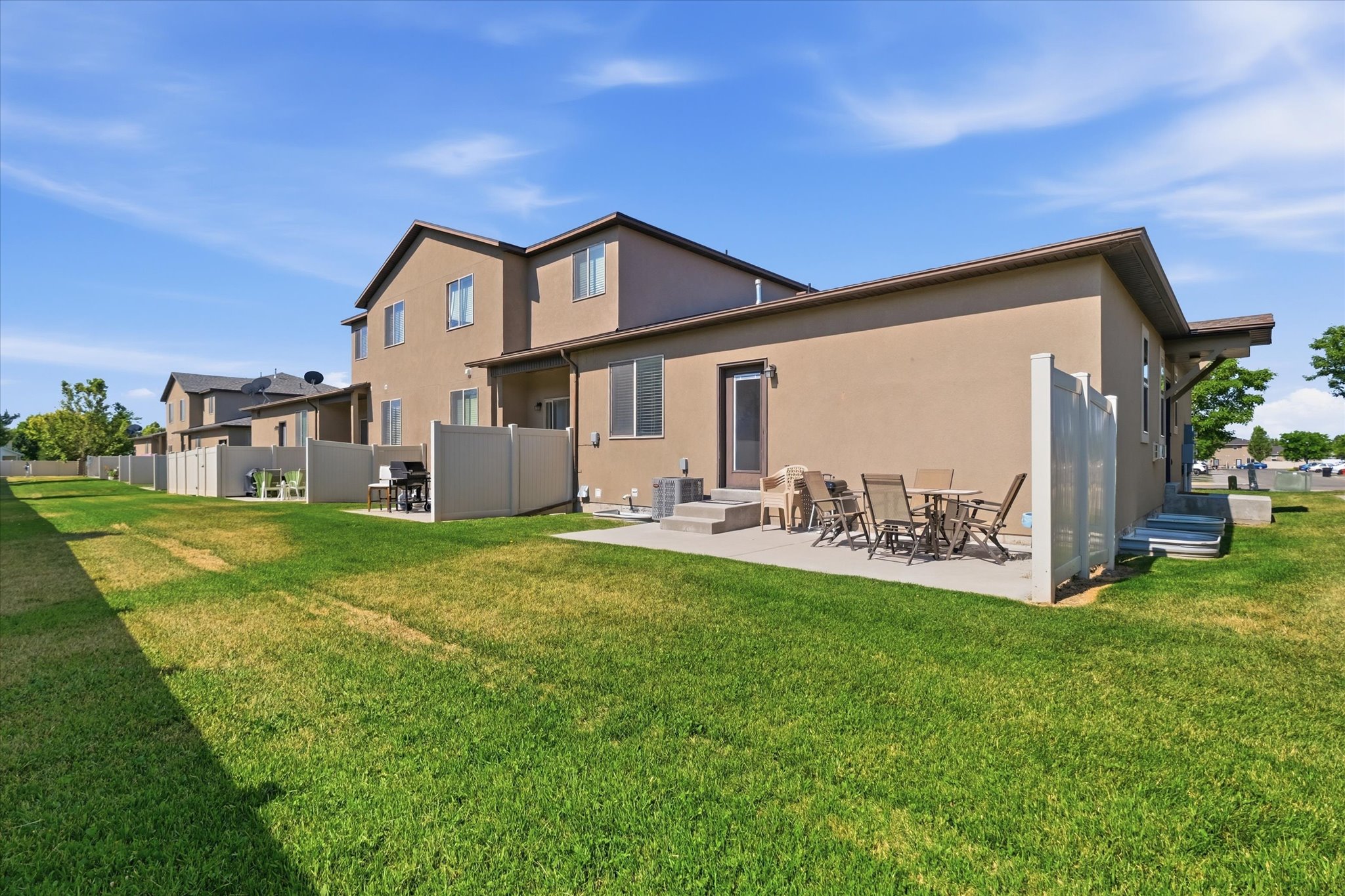 Private rear patio with concrete surfacing and partial privacy fencing, providing outdoor living space
