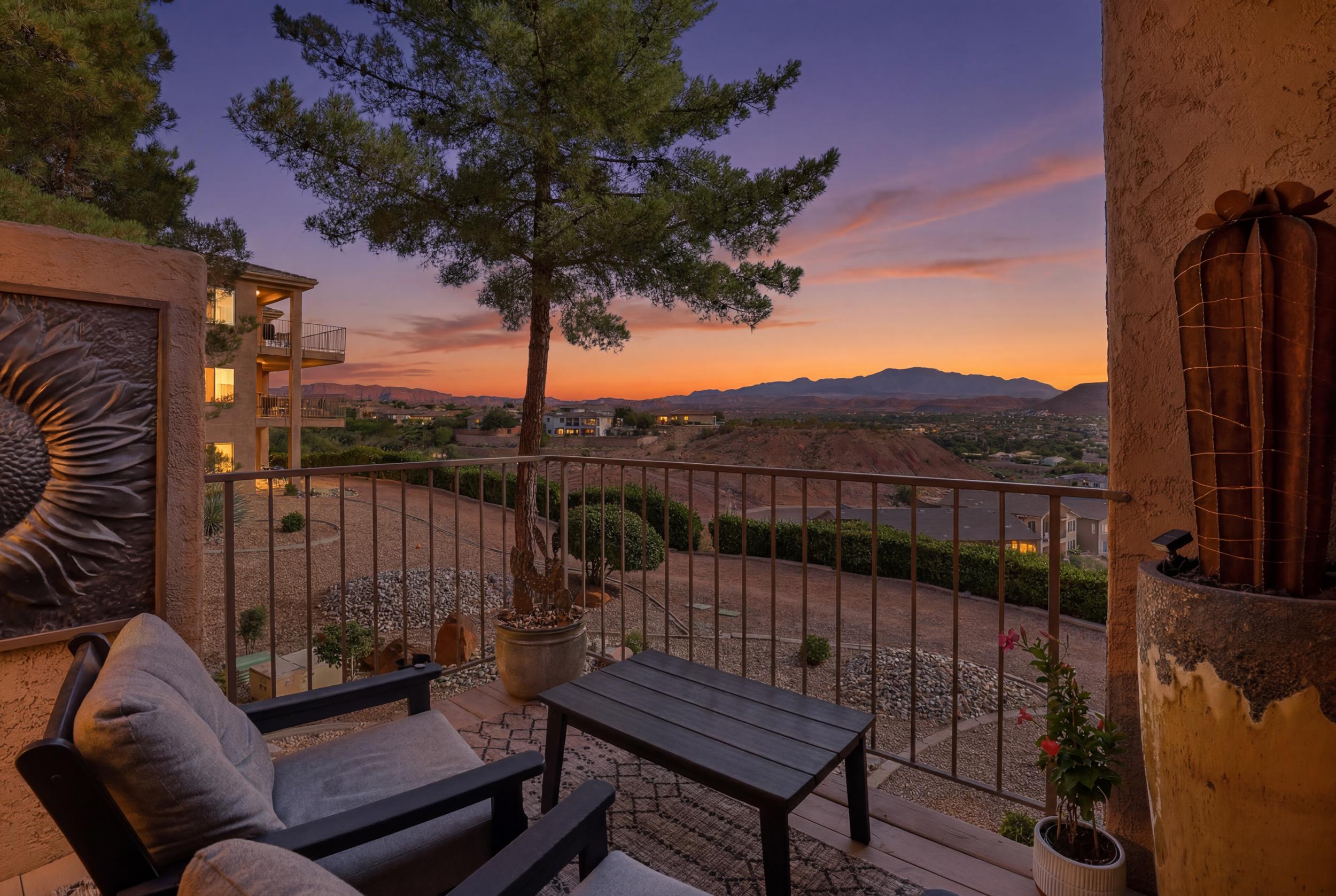 Private balcony featuring durable composite decking and wrought iron railing, overlooking a scenic mountain backdrop and arid landscaping
