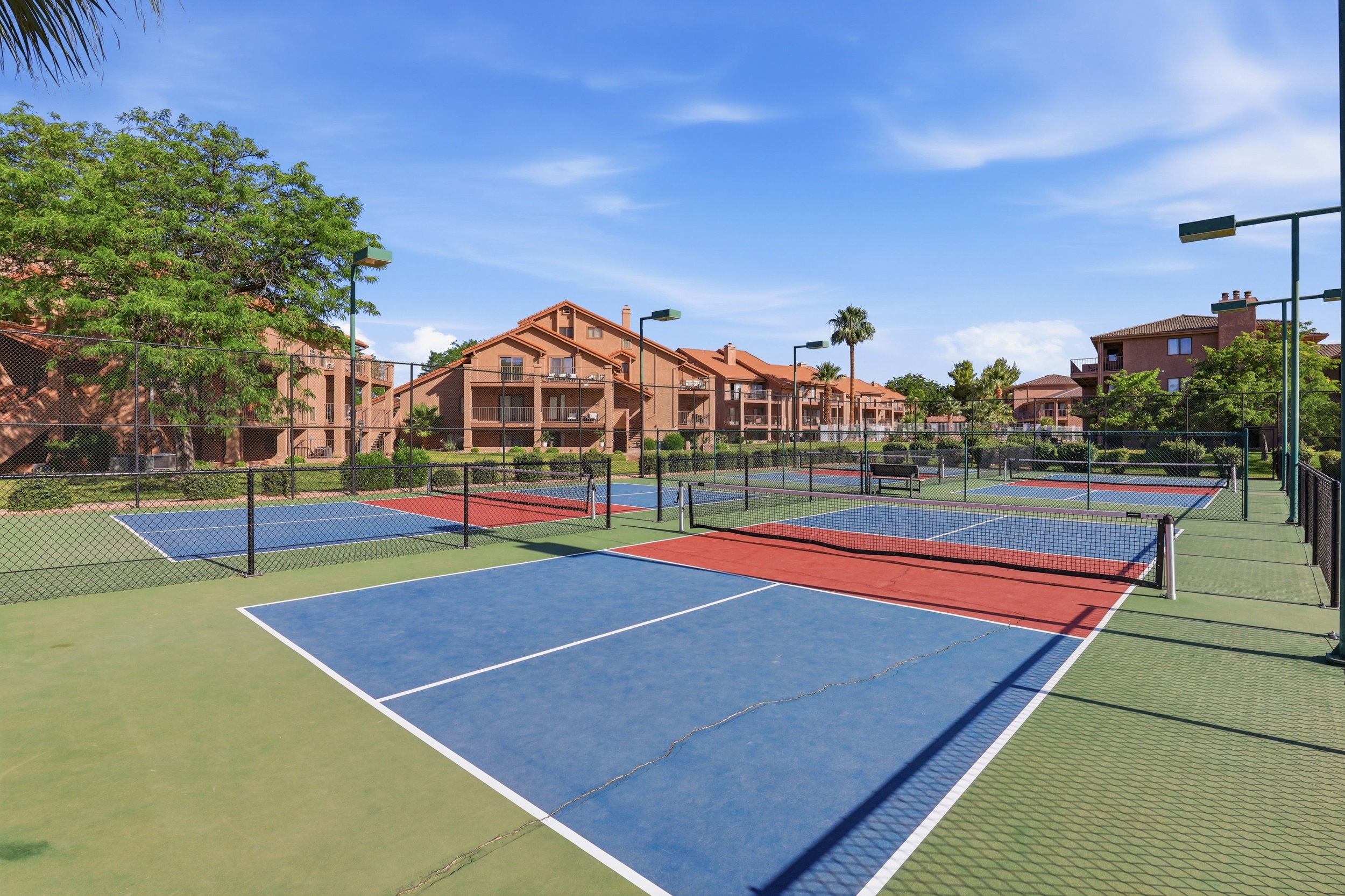 Multiple recreational courts featuring red, blue, and green surfacing