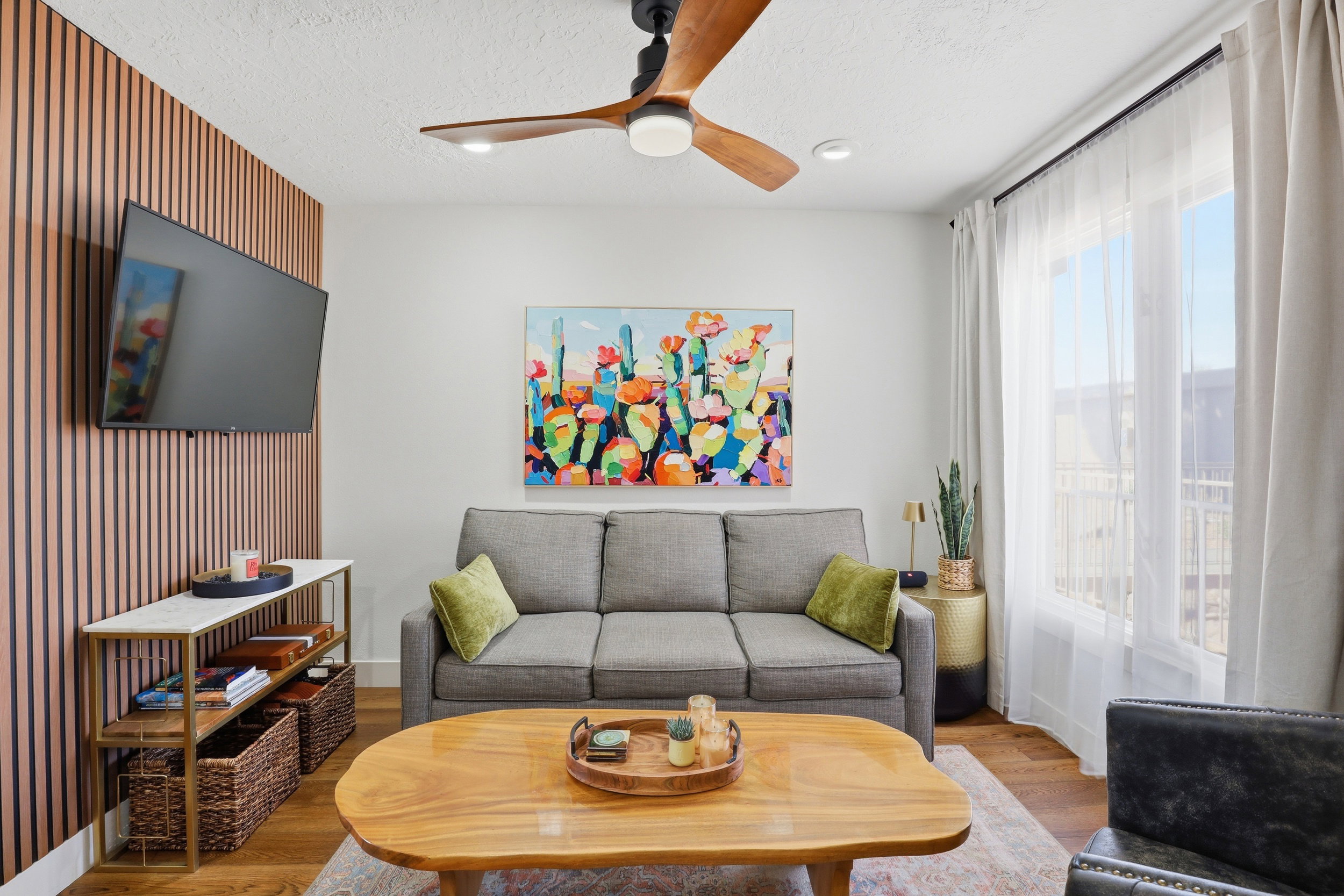 Living area featuring wood-finish flooring, a contemporary ceiling fan, and recessed lighting