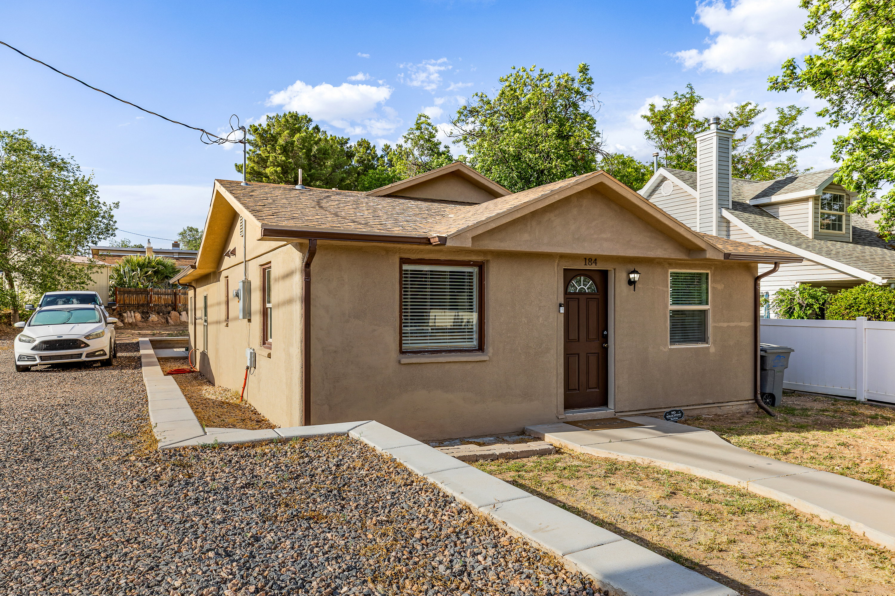 Stucco exterior residence with a composition shingle roof