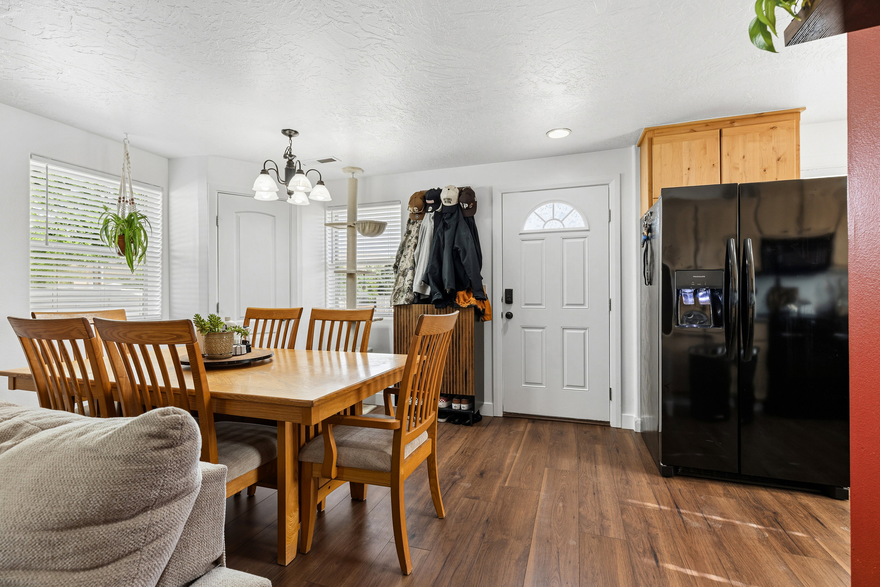 Open-concept living area featuring wood-finish flooring, white walls, and recessed lighting