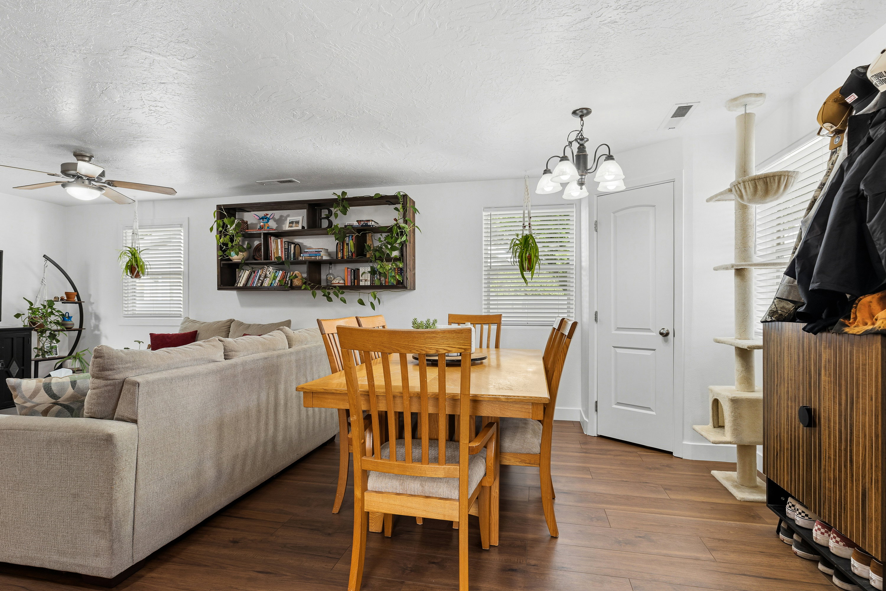 Open-concept living and dining area featuring wood-finish flooring