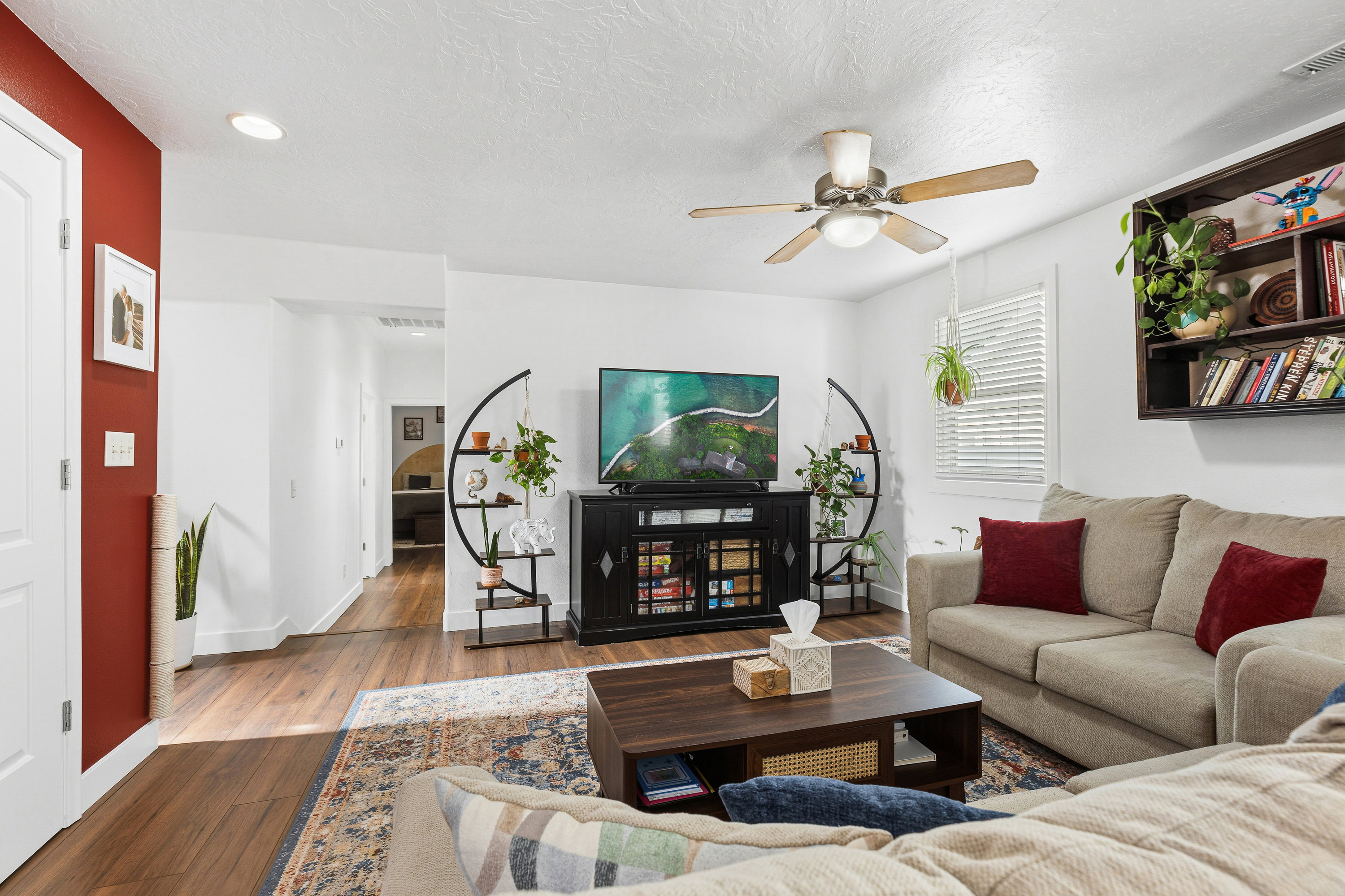 Open-concept living space featuring wood-finish flooring, recessed lighting, and a ceiling fan