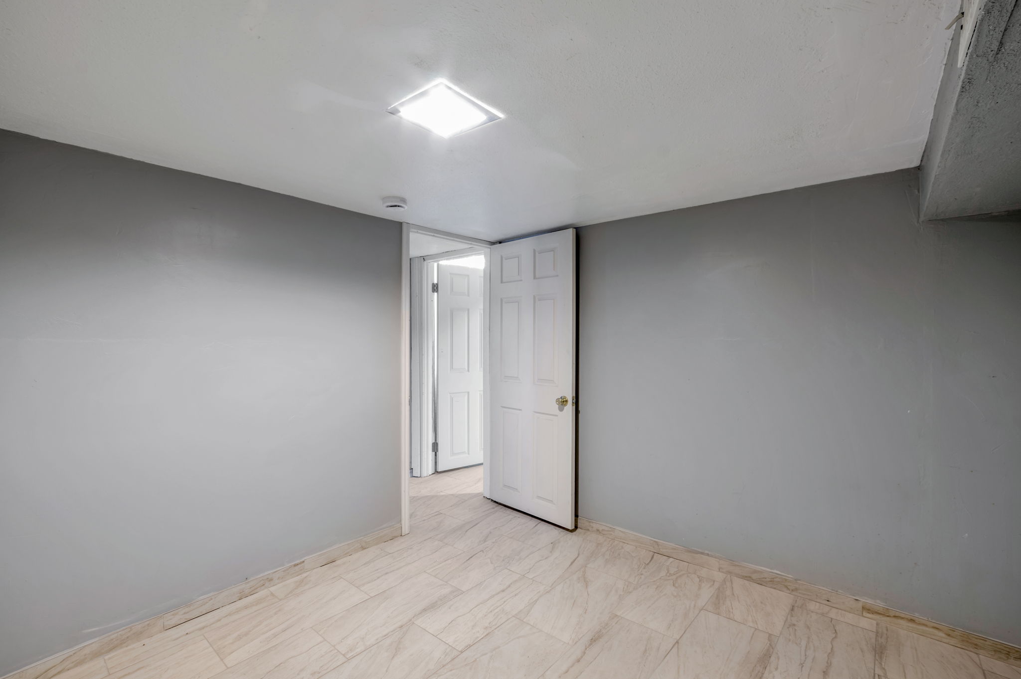 Neutral gray walls complement the light-toned tile flooring