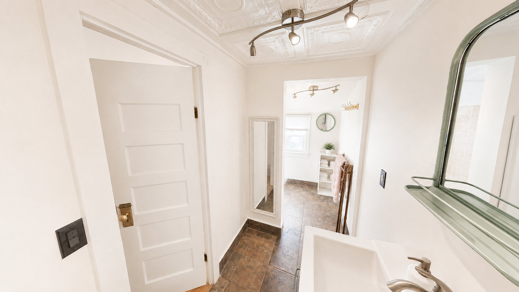 White four-panel interior door with brass hardware