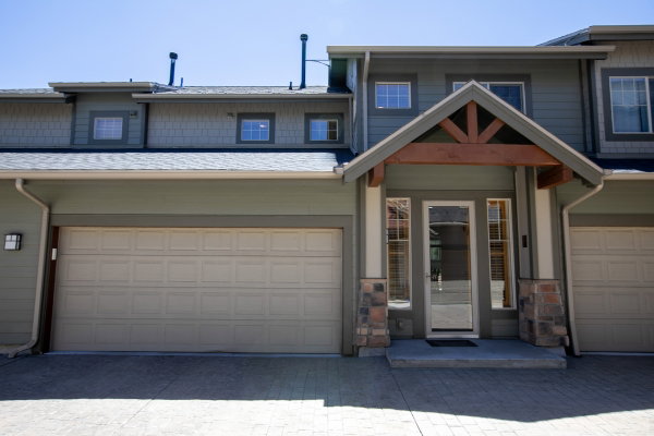 Craftsman-style exterior with stone accents and a wood-beam portico