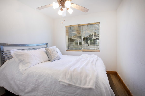 Neutral wall finishes complement the wood-finish flooring in this bedroom