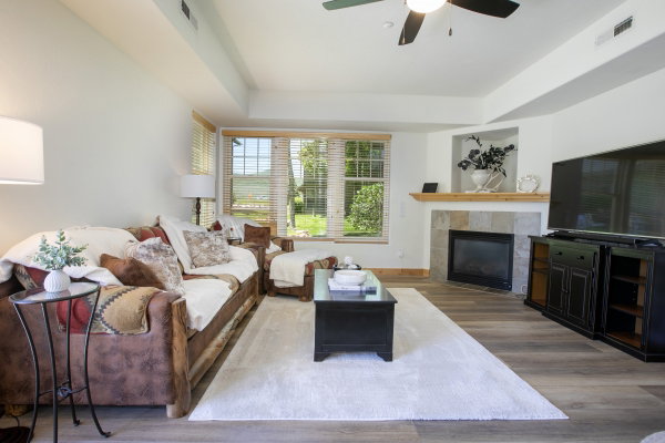 Living area featuring wood-like finish flooring, a ceiling fan, and recessed lighting