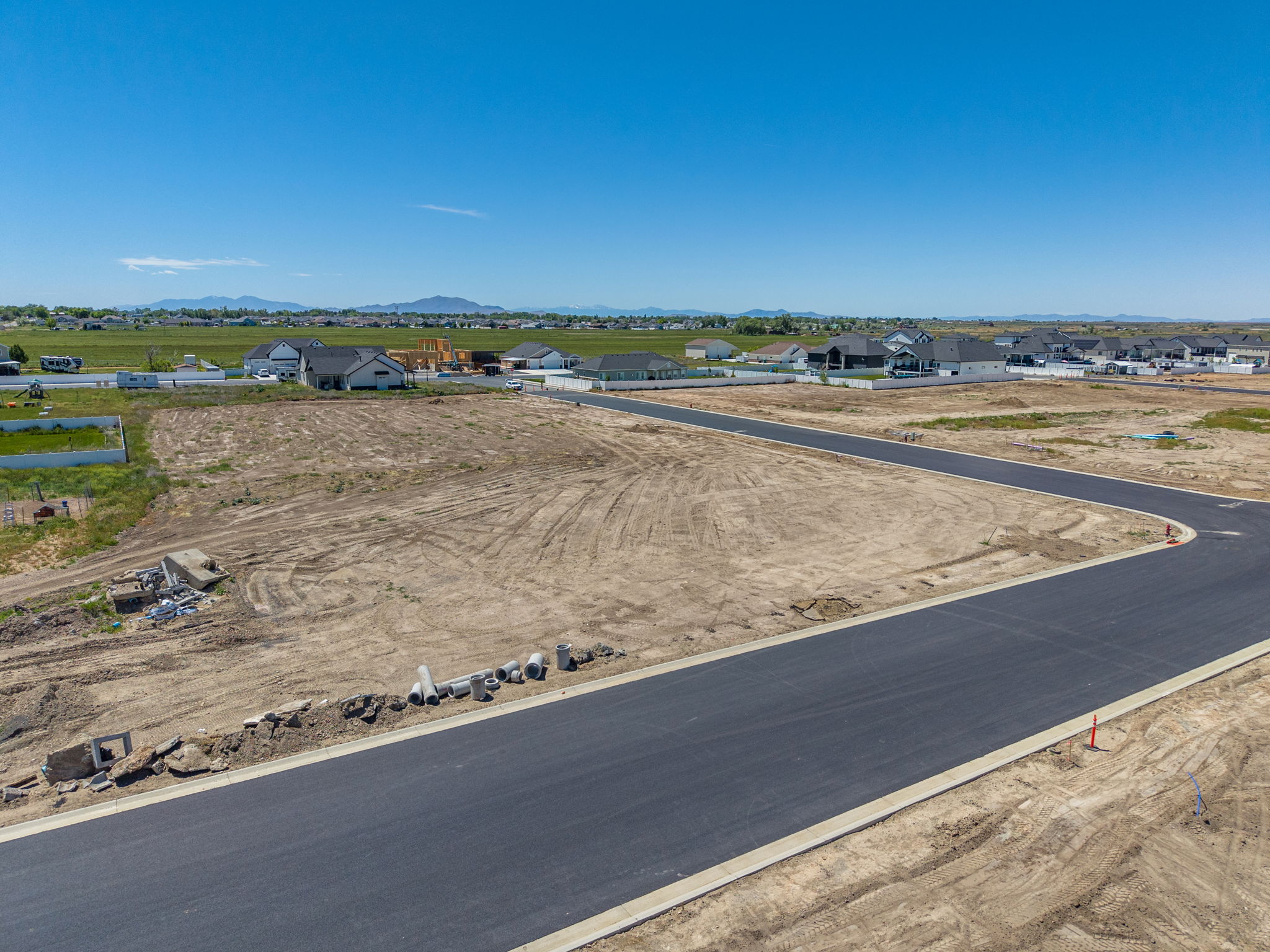 Developed residential area with new asphalt roads and concrete curbing