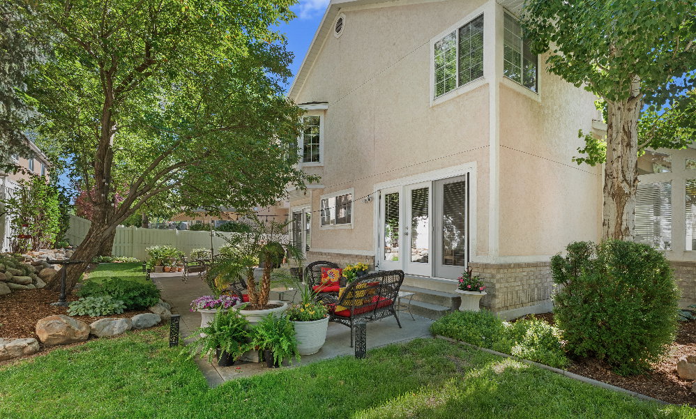 Rear exterior featuring a stucco finish with a stone veneer foundation