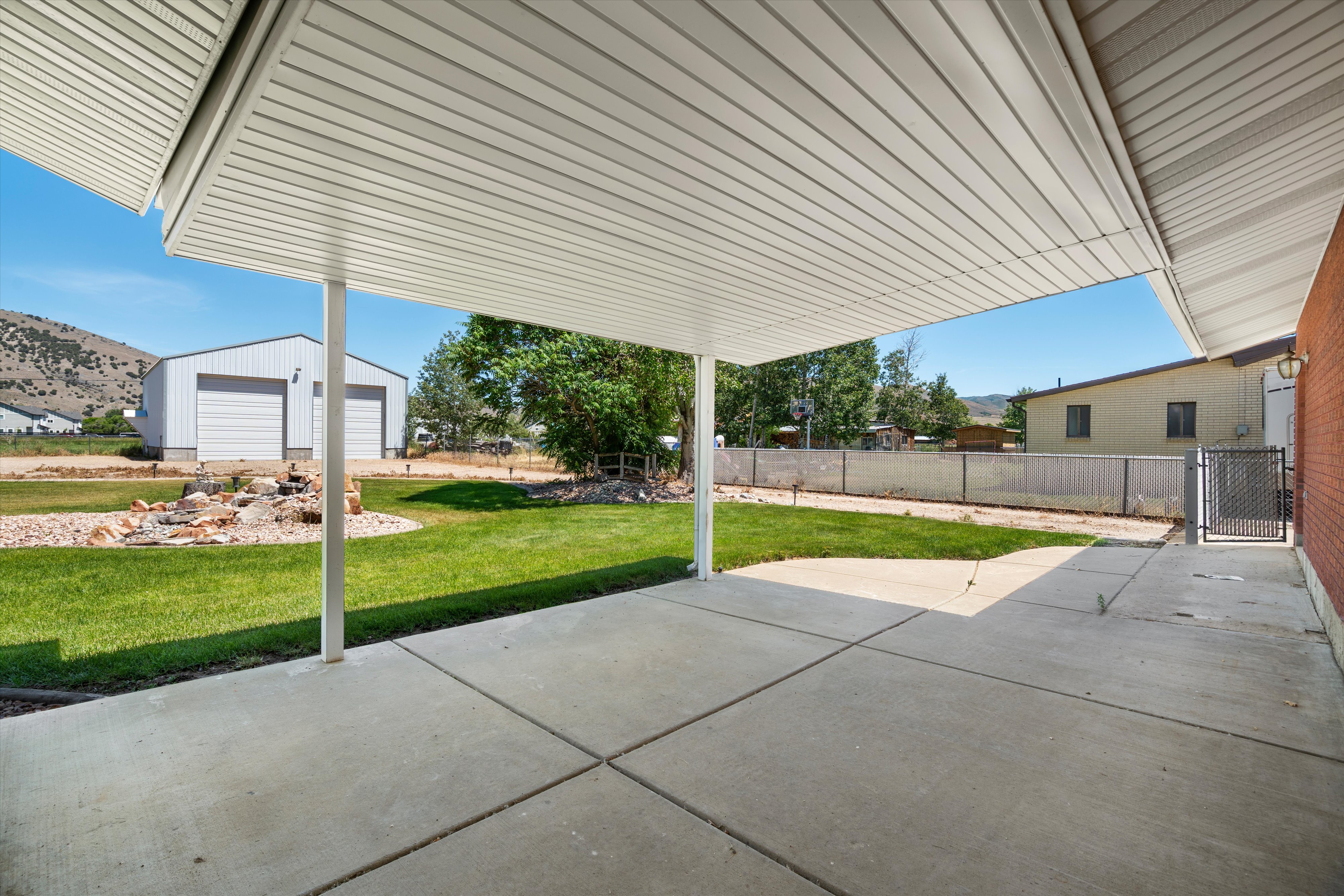 Covered patio featuring a concrete slab and white vinyl soffit ceiling