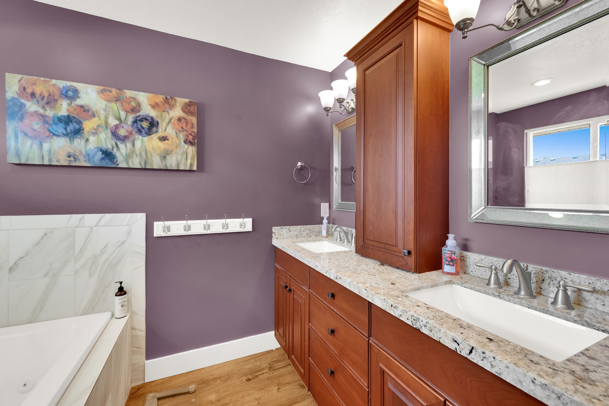 Double vanity with granite-style countertops and integrated sinks