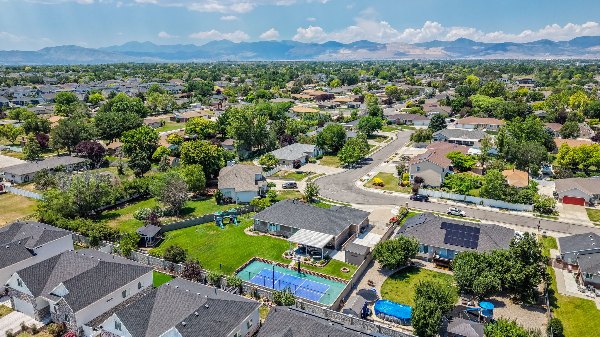 Aerial perspective showcasing a residential neighborhood with distant mountain ranges