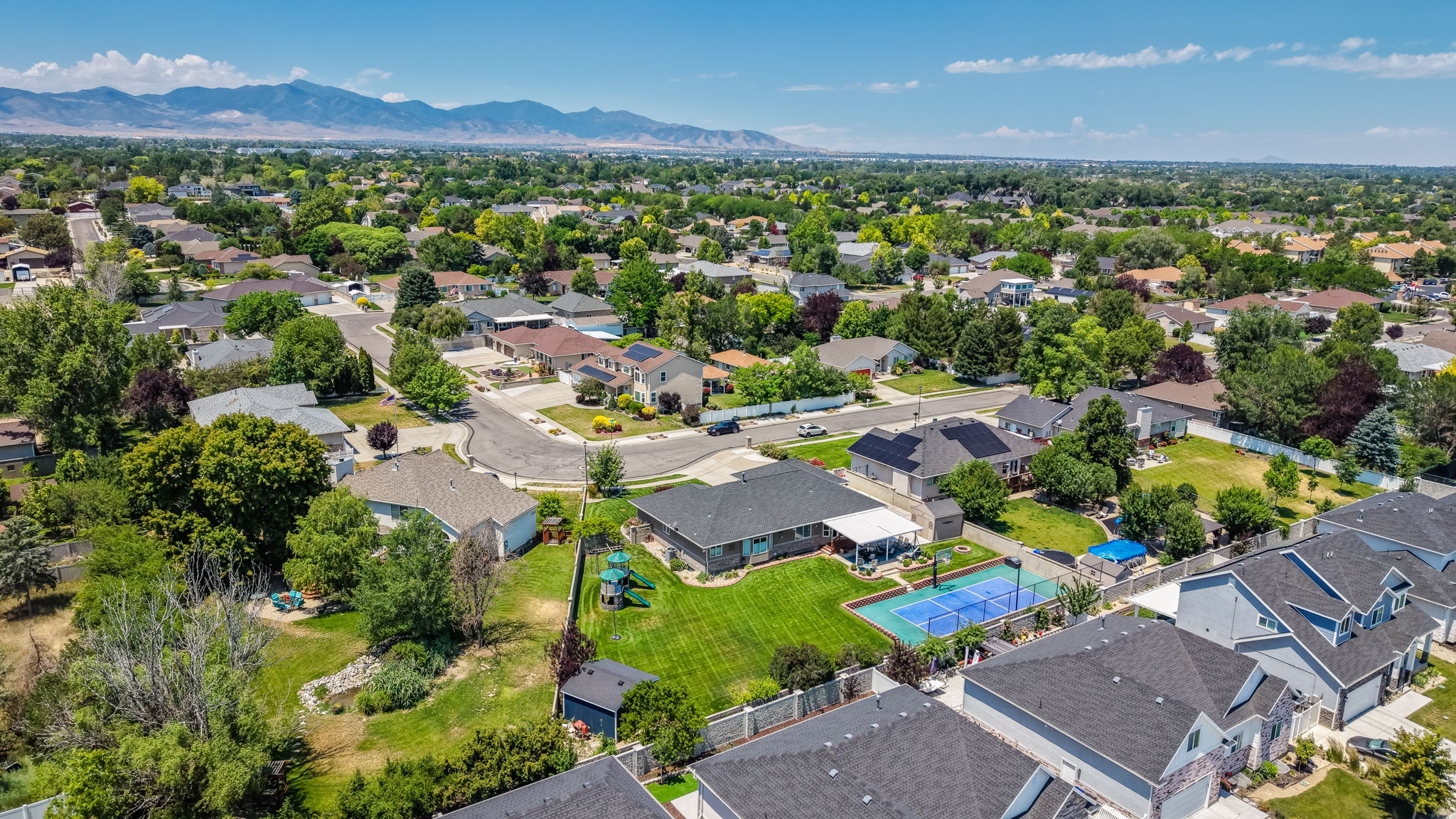 Aerial overview showcasing a residential neighborhood with a mountain backdrop