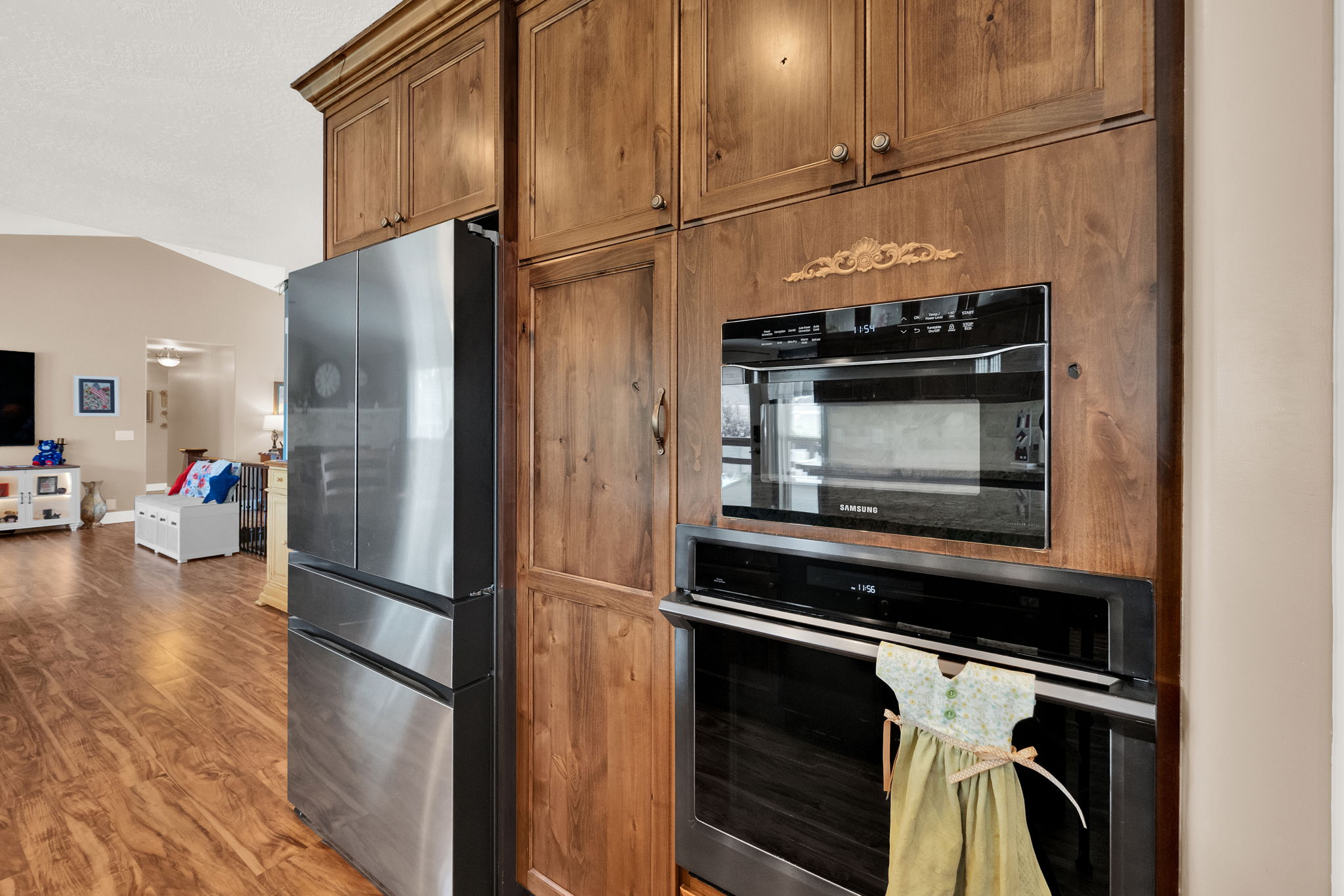 Built-in stainless steel appliances, including a microwave and oven, are integrated into custom wood cabinetry