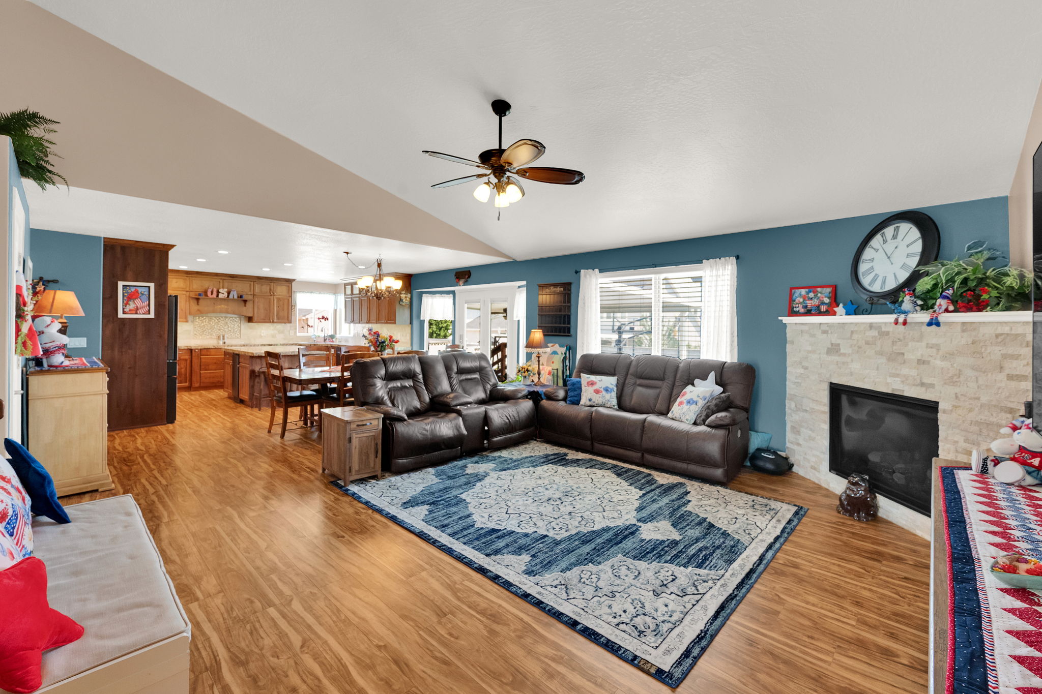 Vaulted ceilings accentuating the open-concept living area with wood-finish flooring