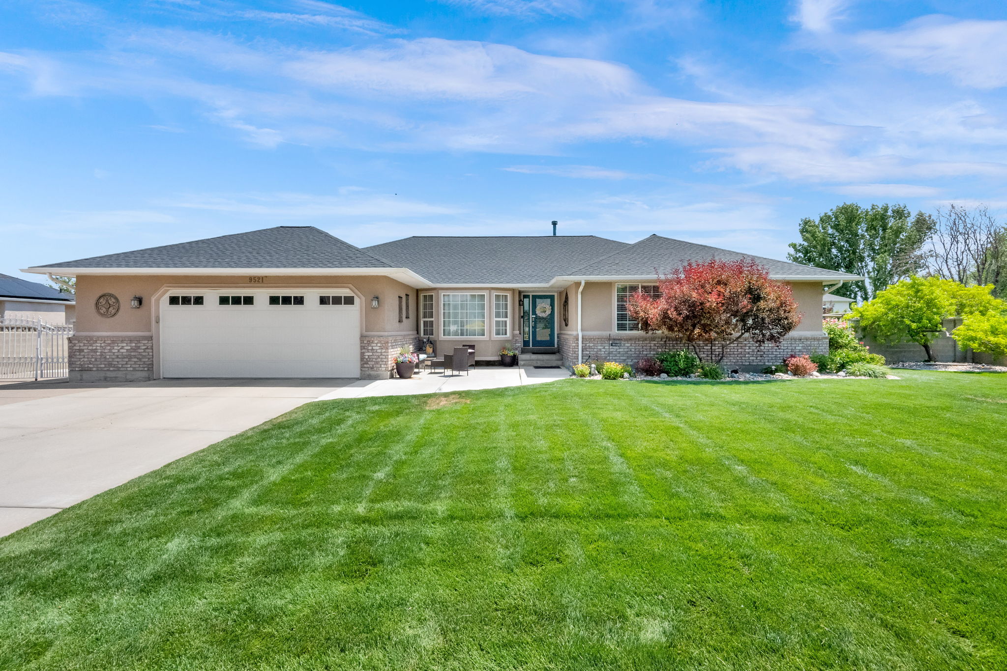 Ranch-style exterior featuring stucco siding and a stone accent facade