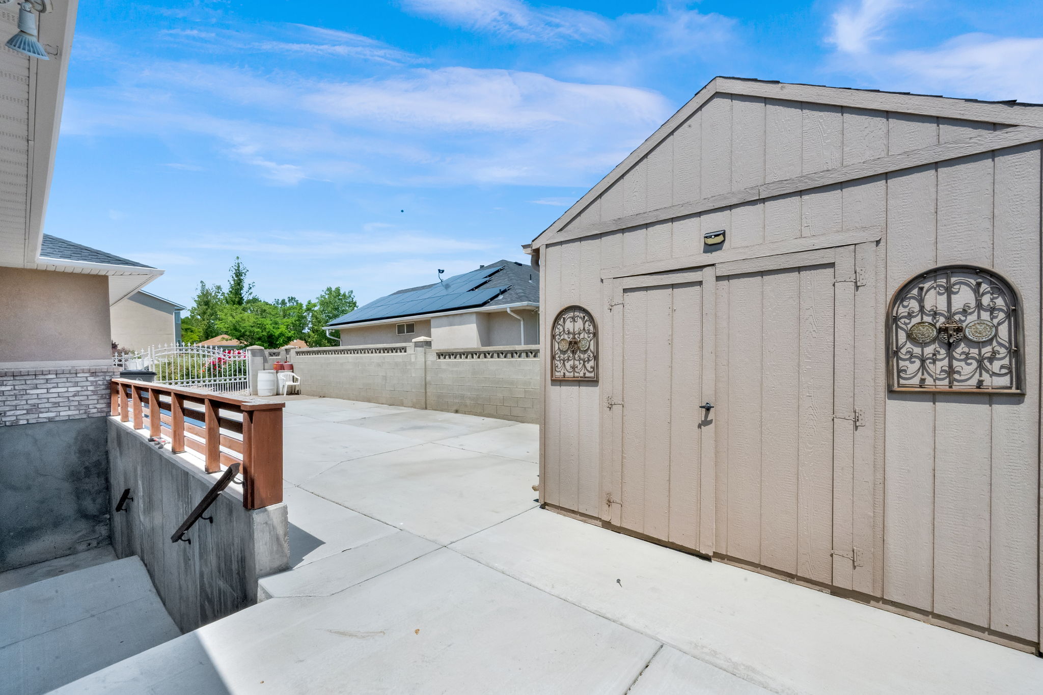 Exterior shed featuring double doors and decorative metal accents