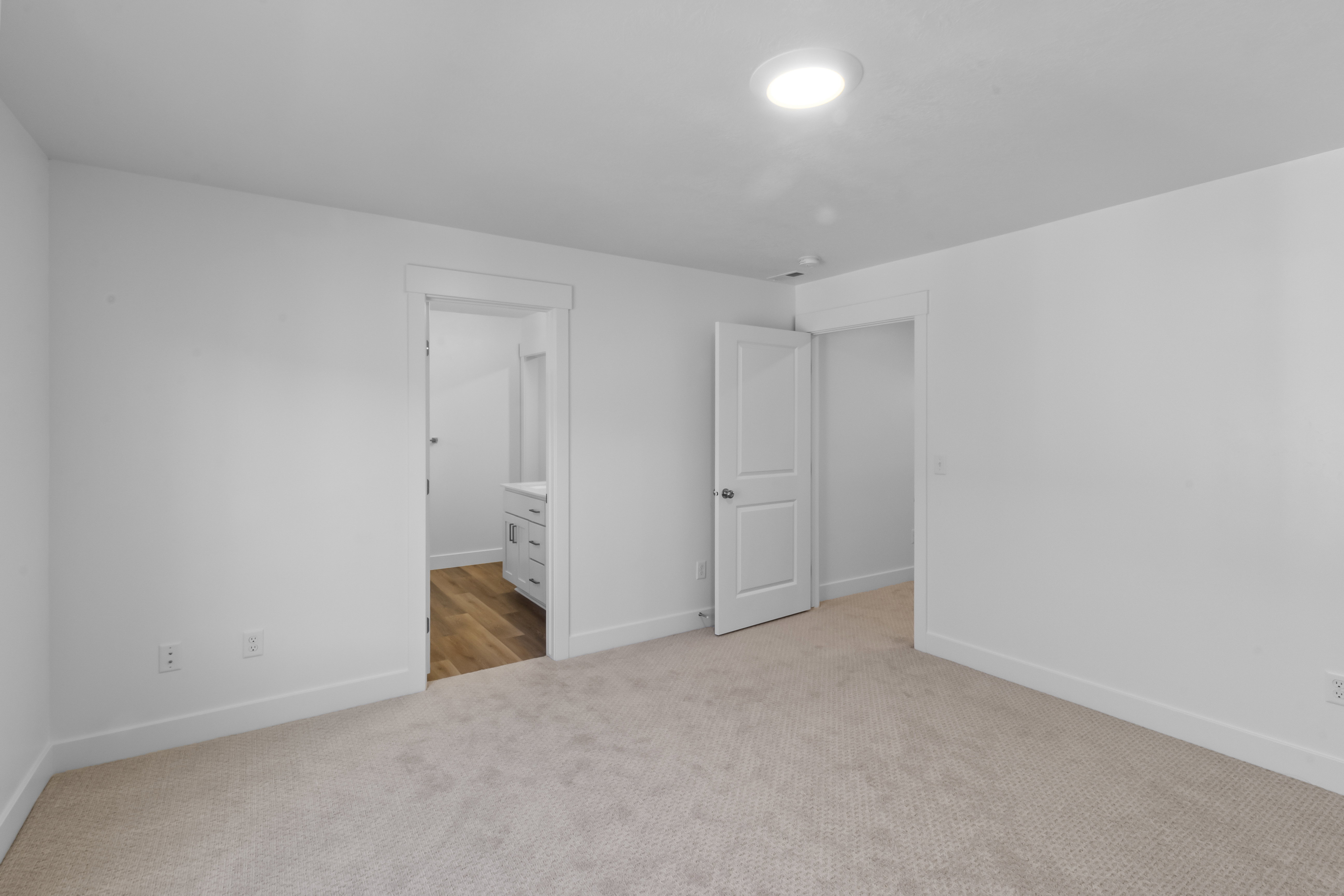 Carpeted room with recessed lighting and white baseboards