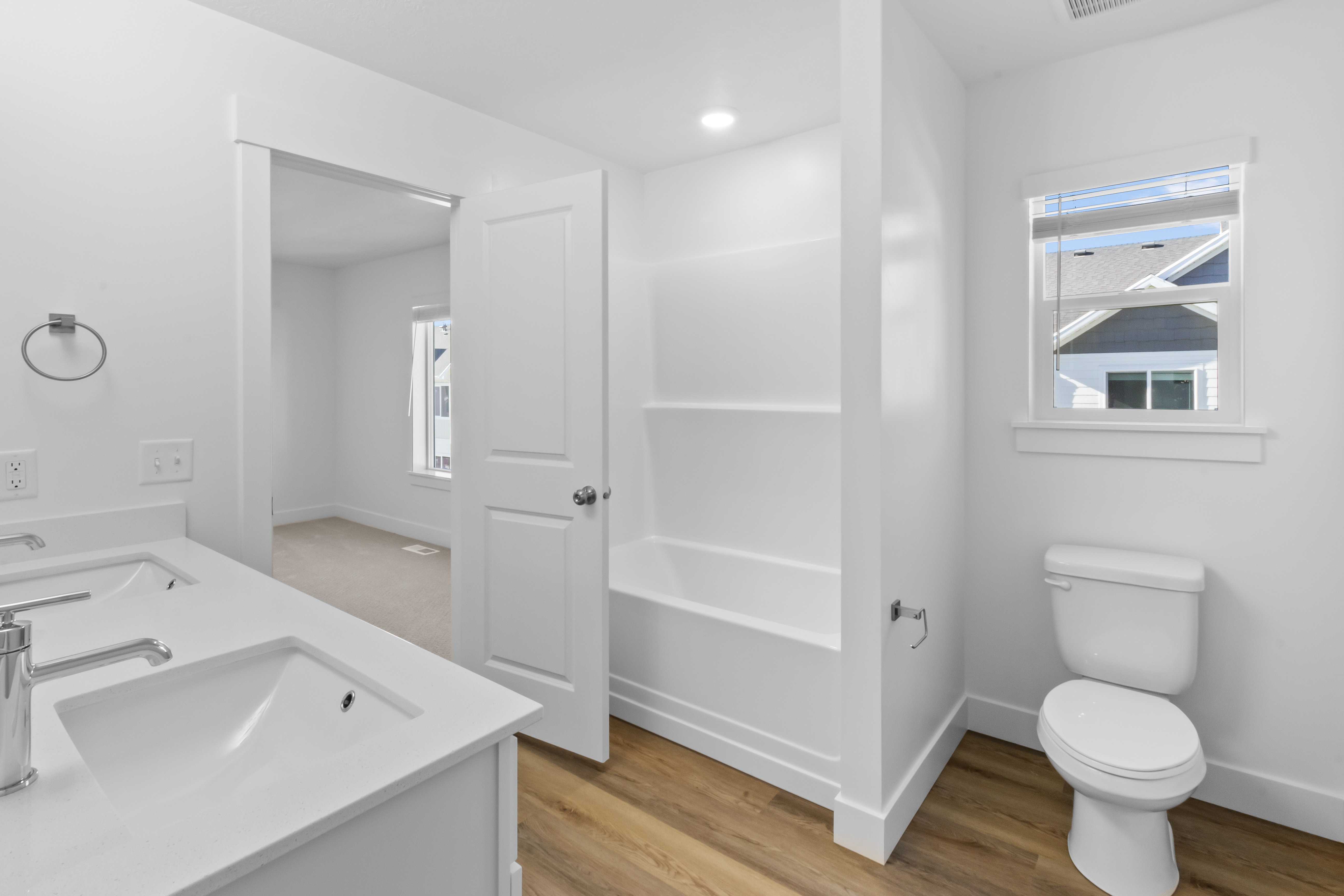 Bathroom with a double vanity featuring integrated rectangular sinks and chrome faucets