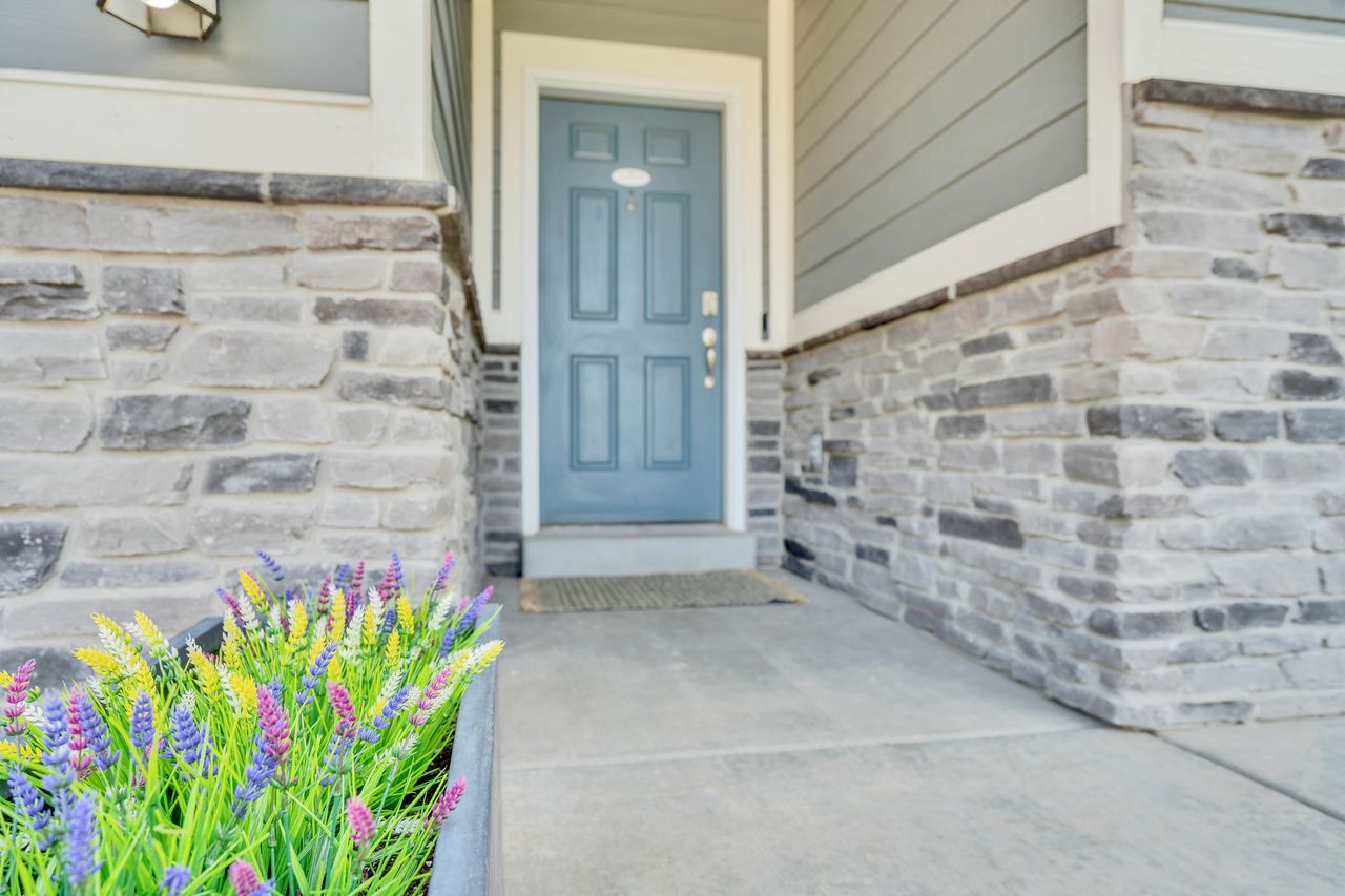 Stone veneer facade with light blue entry door