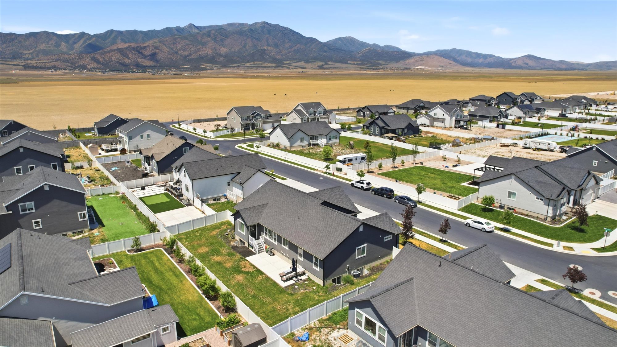 Contemporary residential development featuring a range of single-family homes with dark-toned roofs and light-toned siding