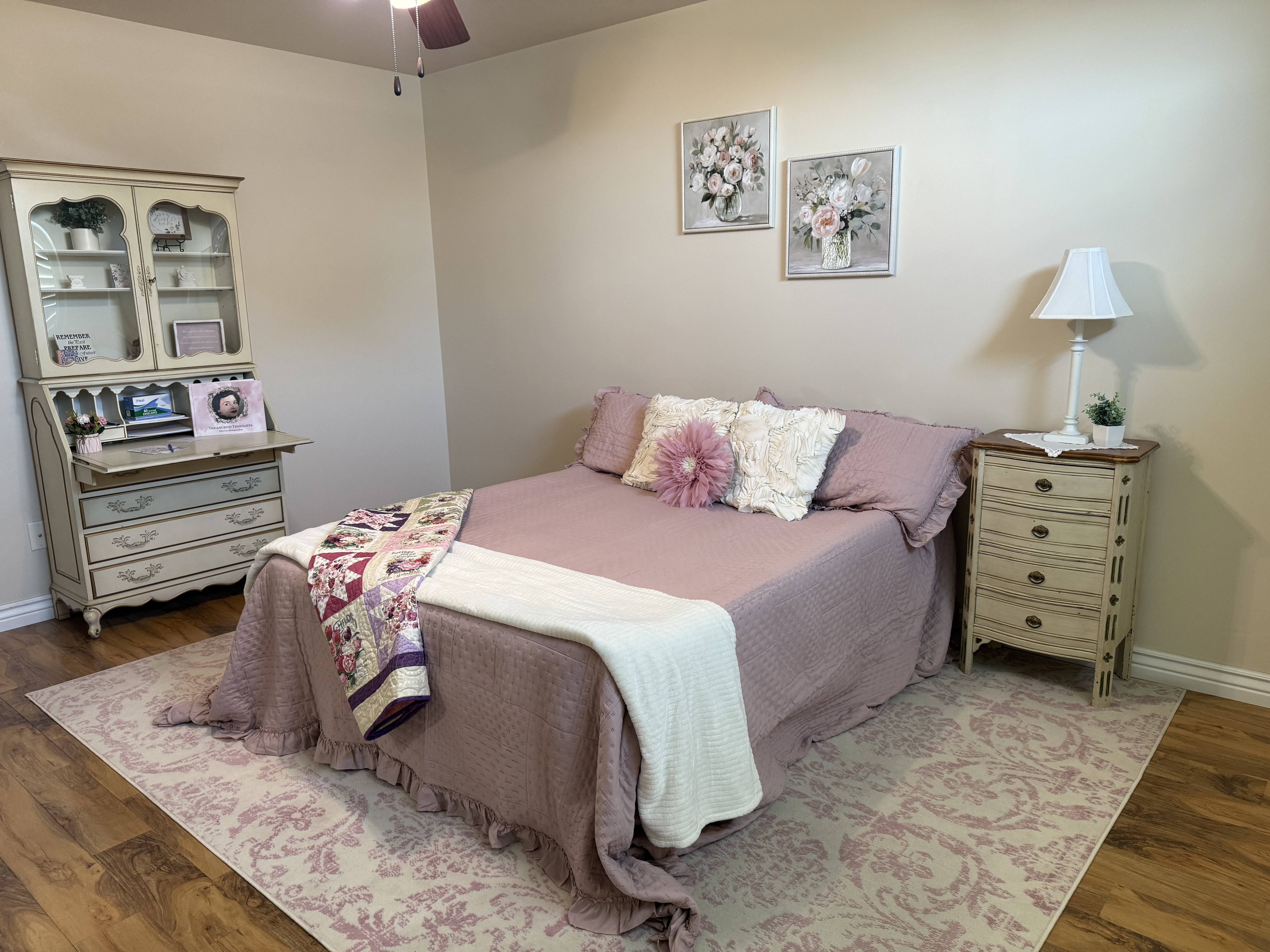 Warm wood-finish flooring complements the neutral wall color