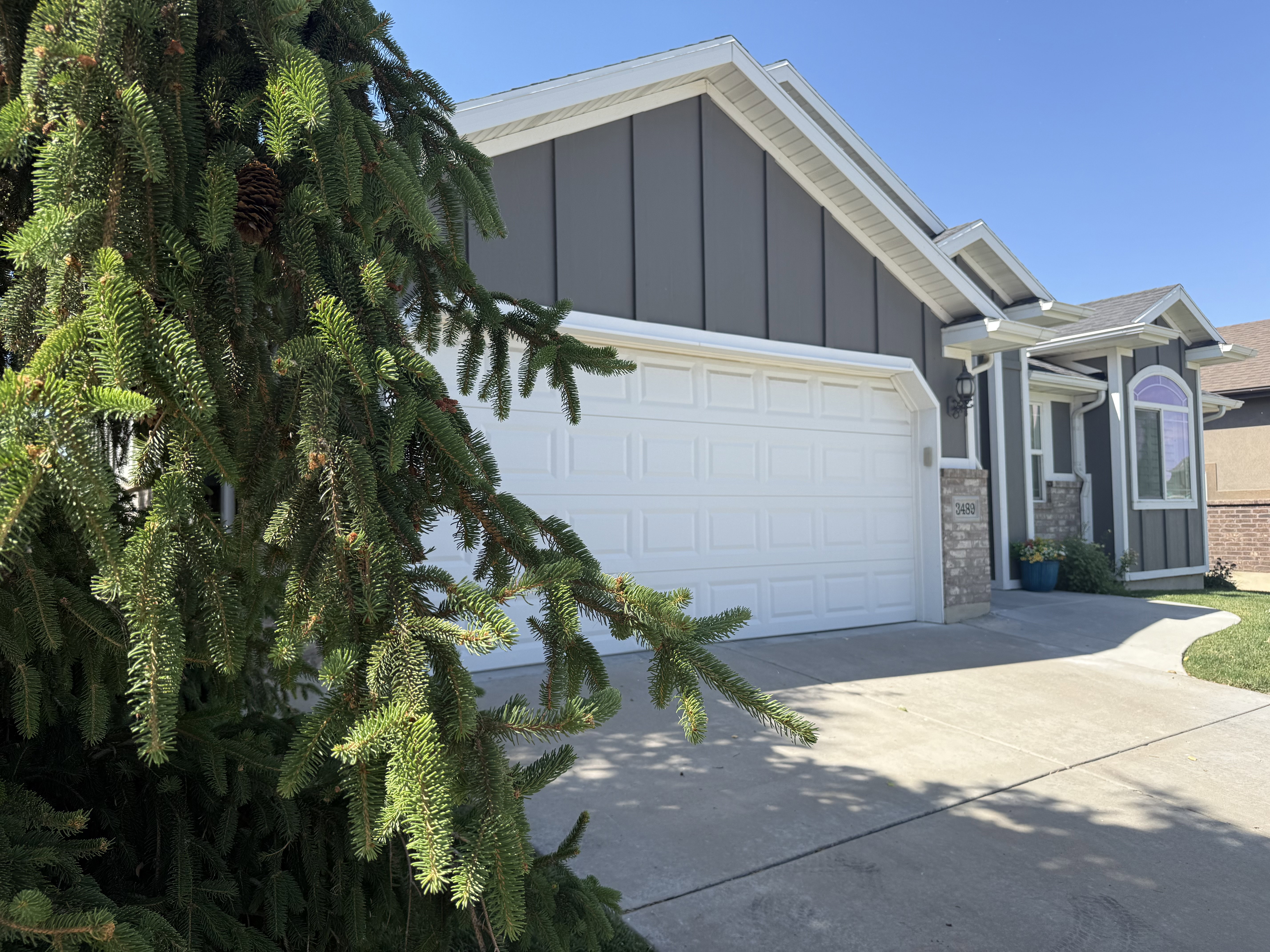 Contemporary exterior featuring dark gray vertical siding and white trim
