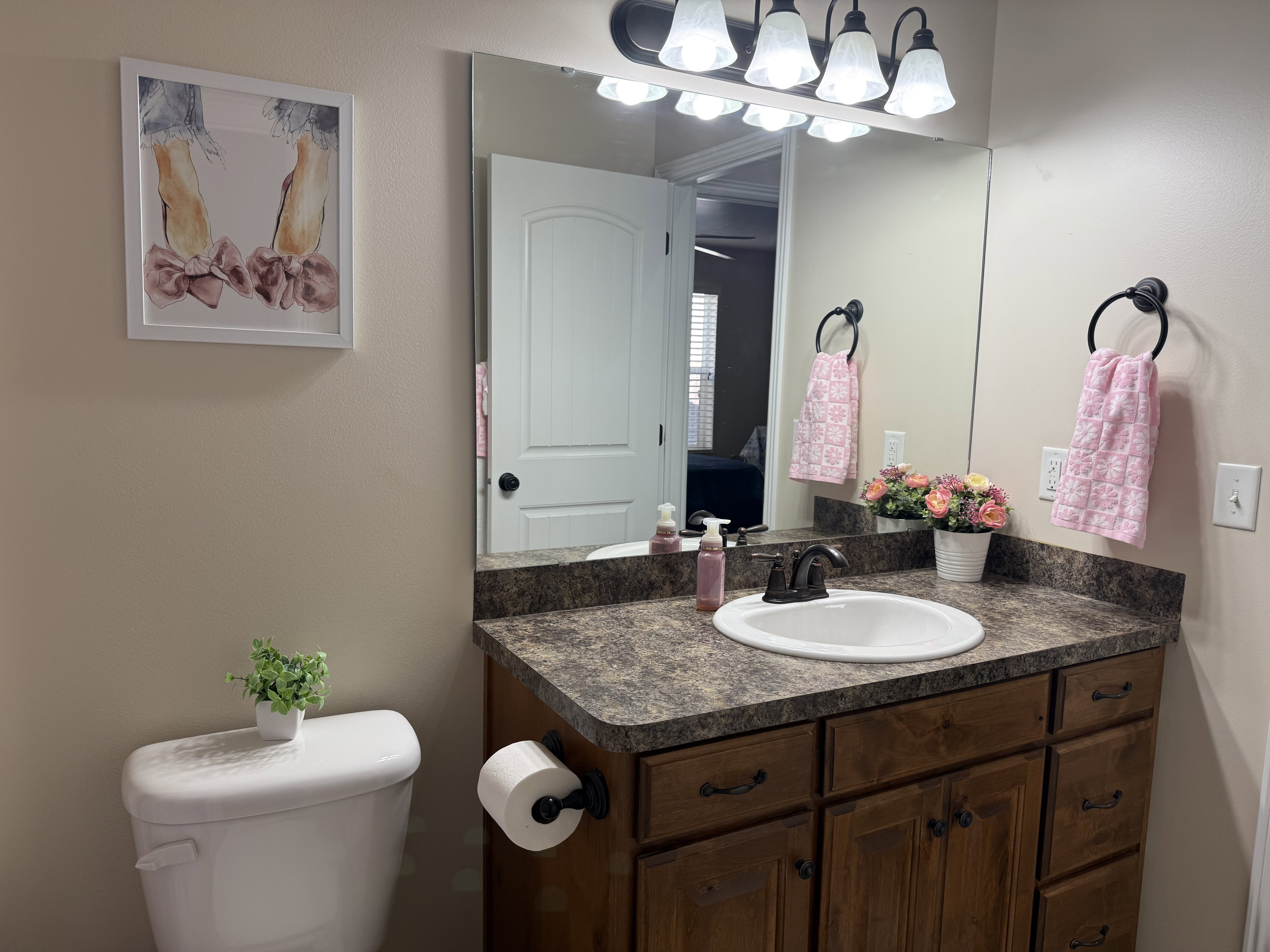 Vanity with countertop, integrated sink, and wood-finish cabinetry