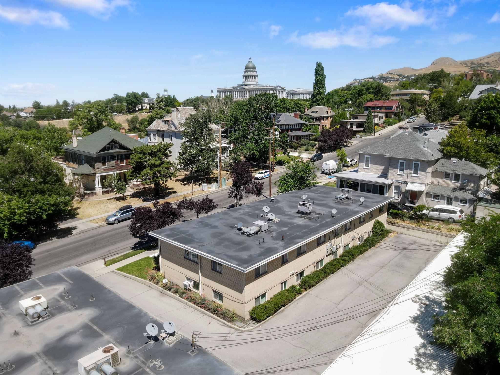 Two-story multifamily building with a flat roof and multiple rooftop units