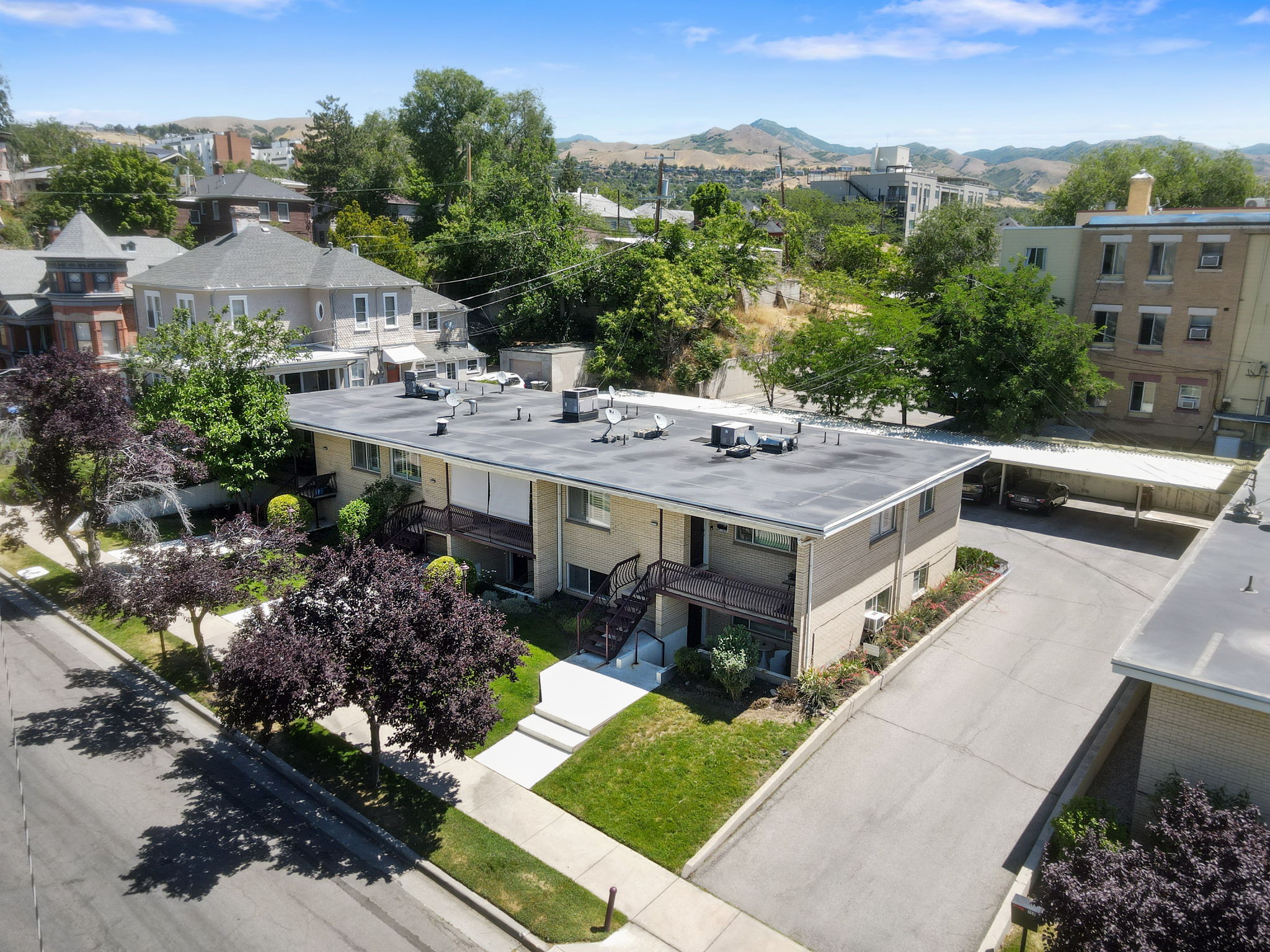 Multi-unit residential building featuring a flat roof and brick facade