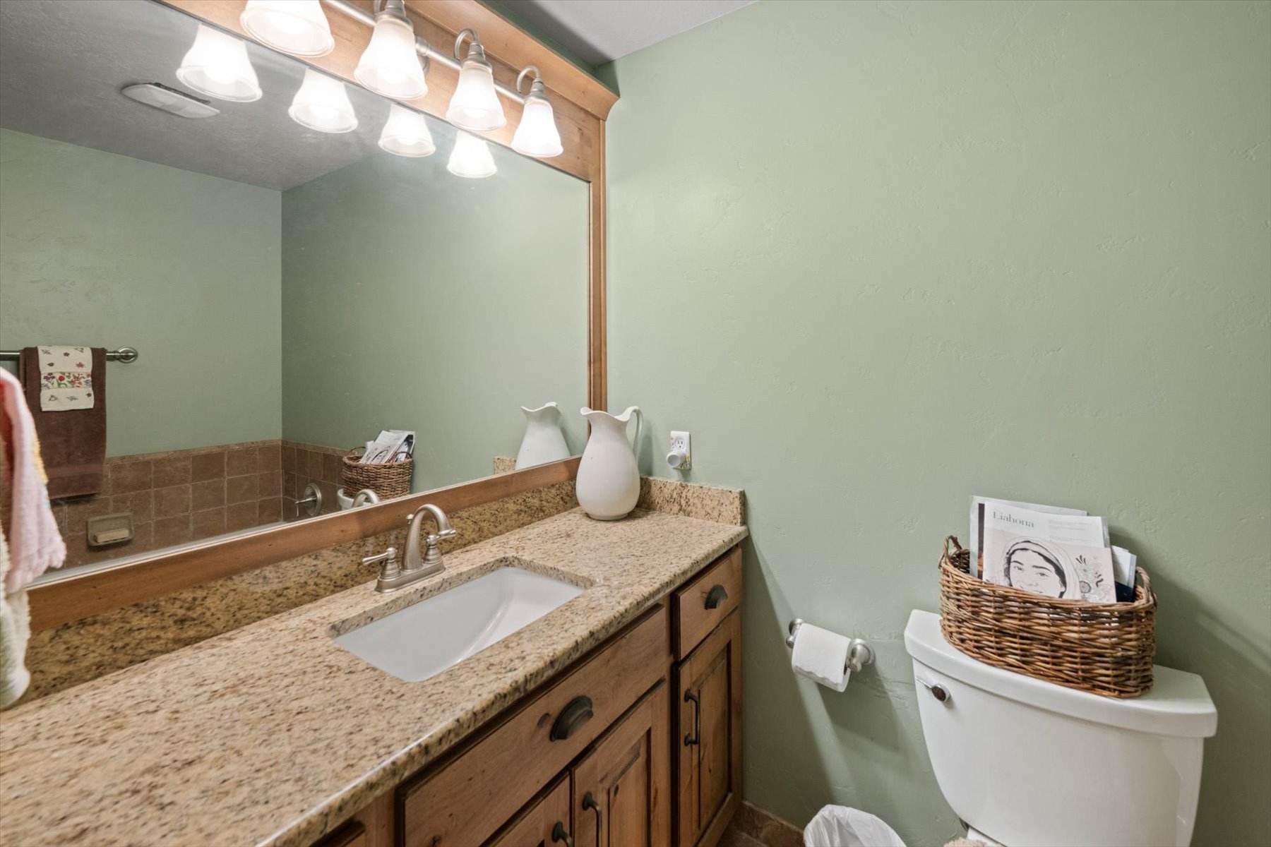 Bathroom featuring a granite countertop vanity with an undermount sink