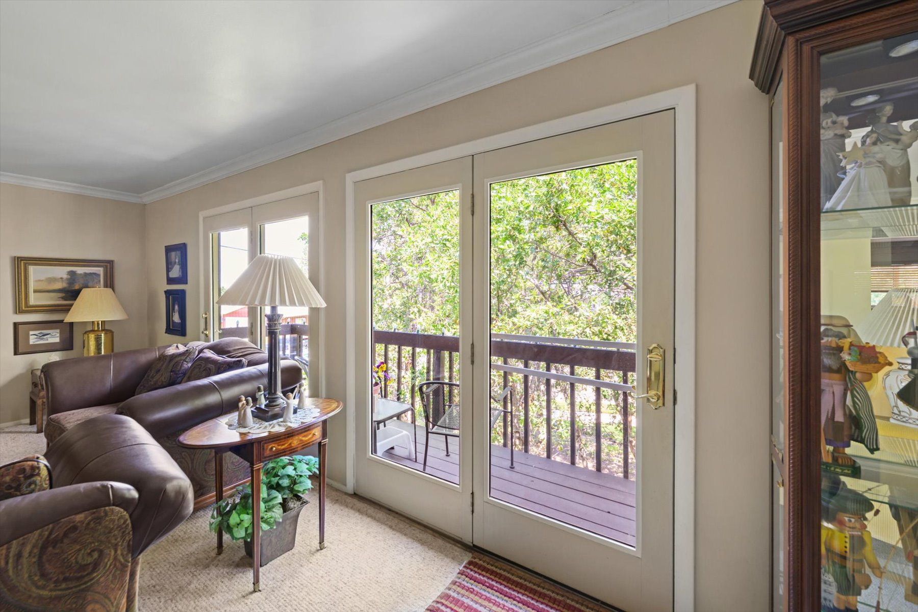 Glass-paneled French doors opening to an exterior balcony