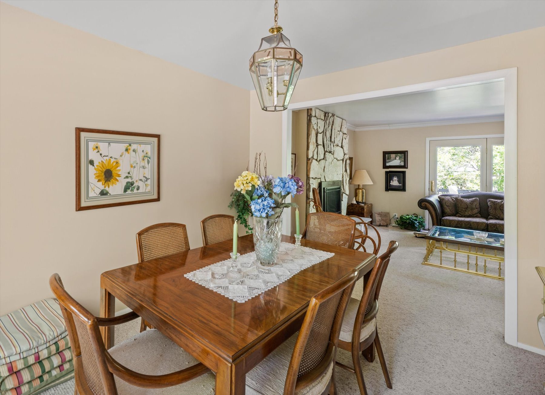 Dining area featuring a wood-finish table and caned chairs