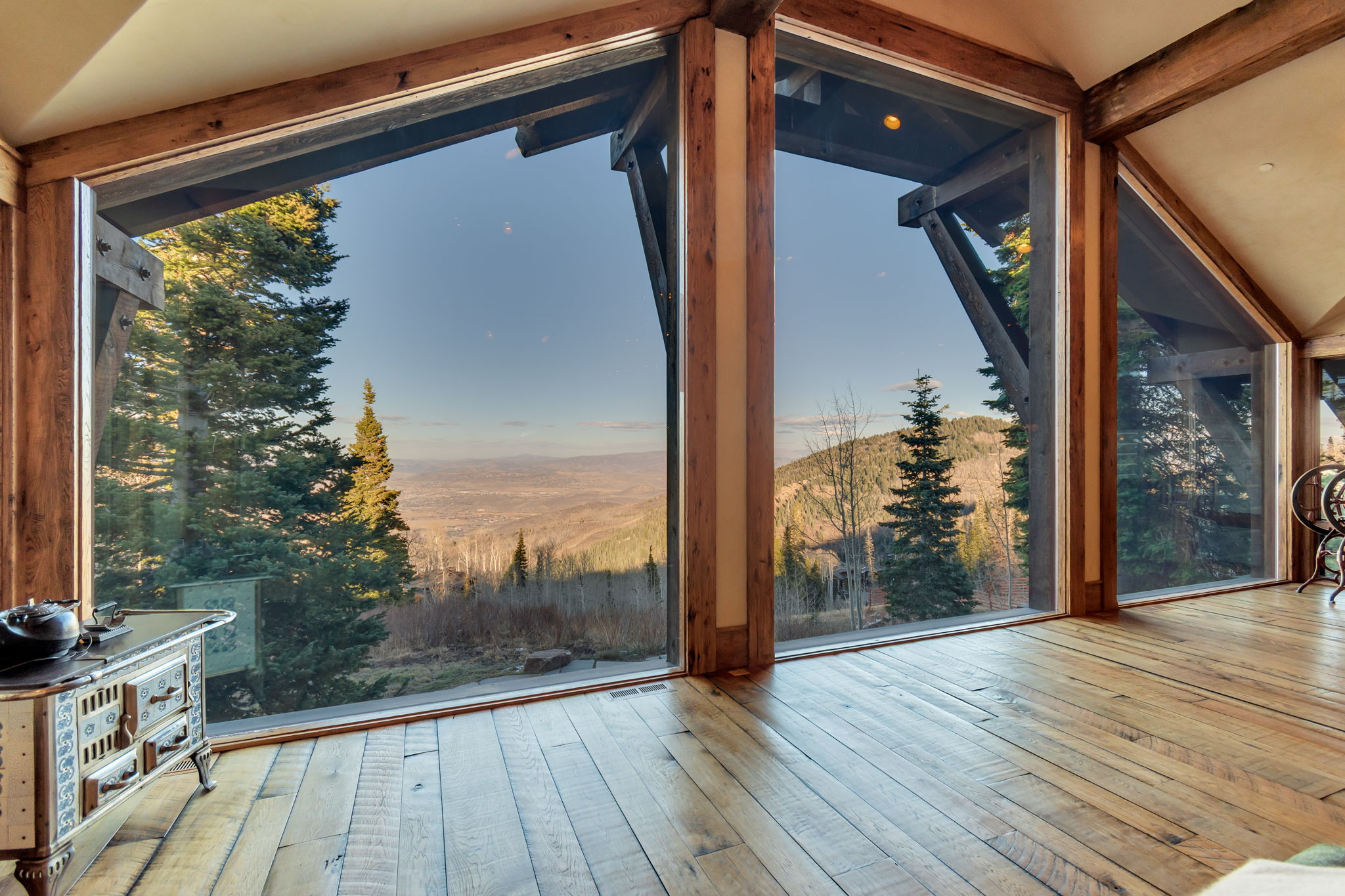 Expansive floor-to-ceiling windows with natural wood framing