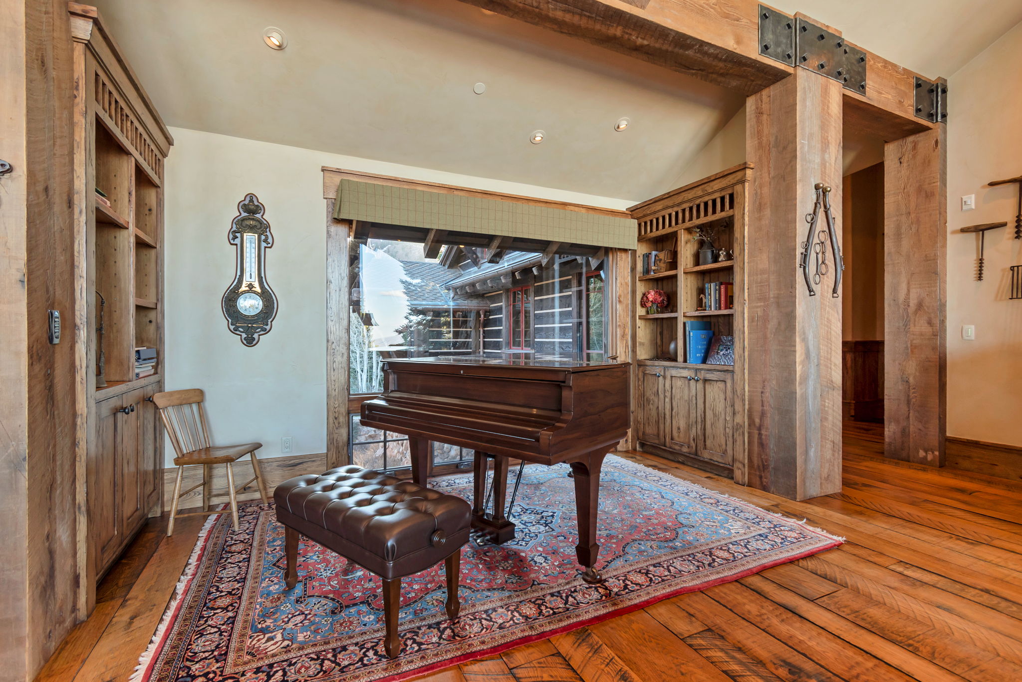 Hardwood flooring and exposed timber beams define this room with built-in wooden cabinetry