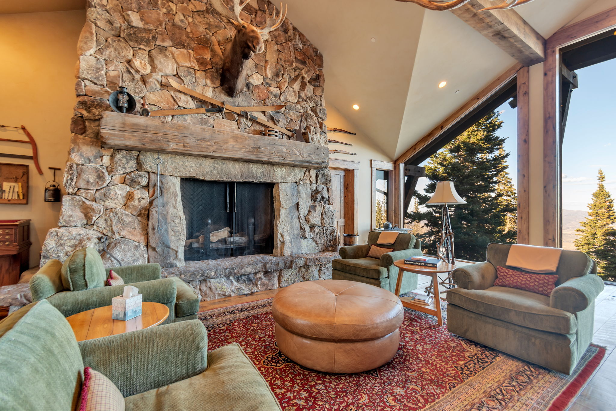 Stone-clad fireplace featuring a substantial wood mantel