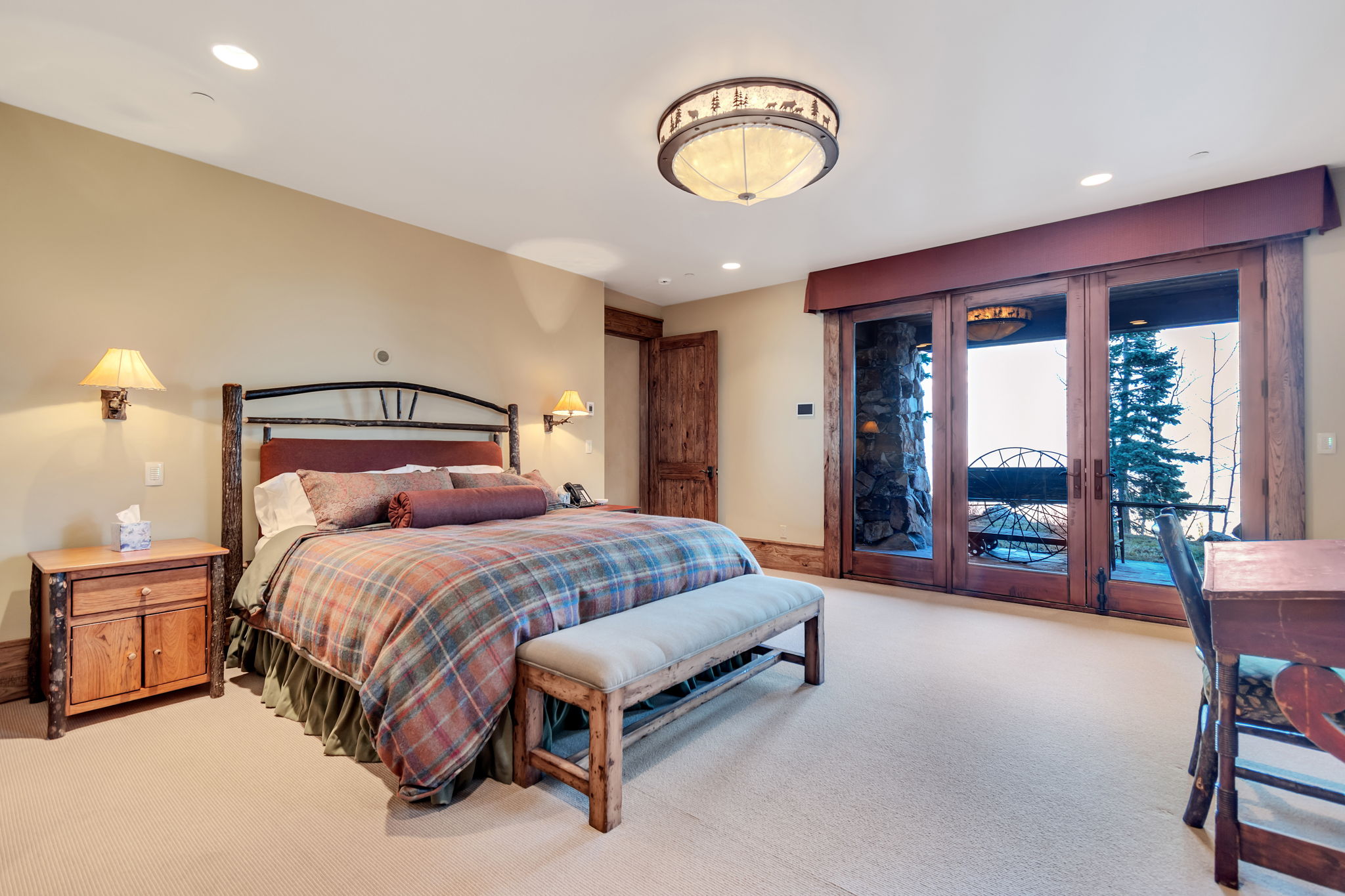 Spacious room featuring light-colored carpet flooring, recessed lighting, and a decorative flush-mount ceiling fixture