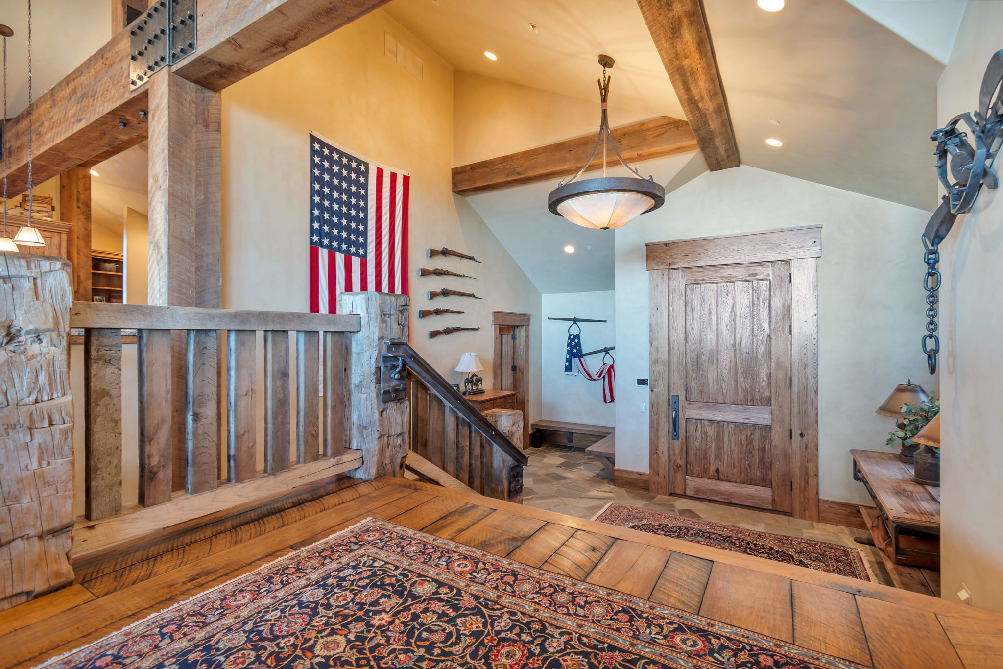Entryway featuring a solid wood door, vaulted ceilings with exposed wood beams, and recessed lighting