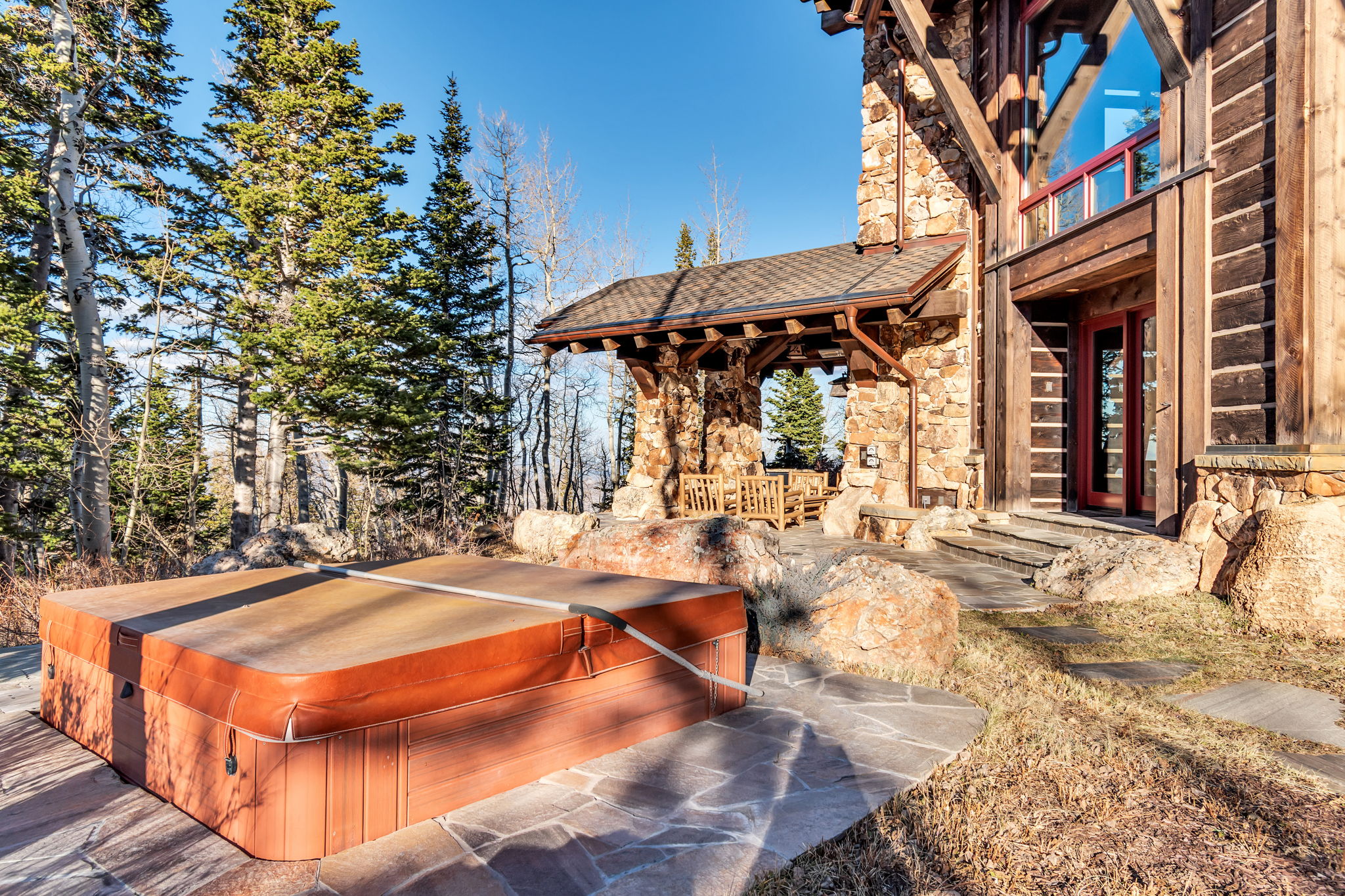 Outdoor spa with cover set on flagstone patio