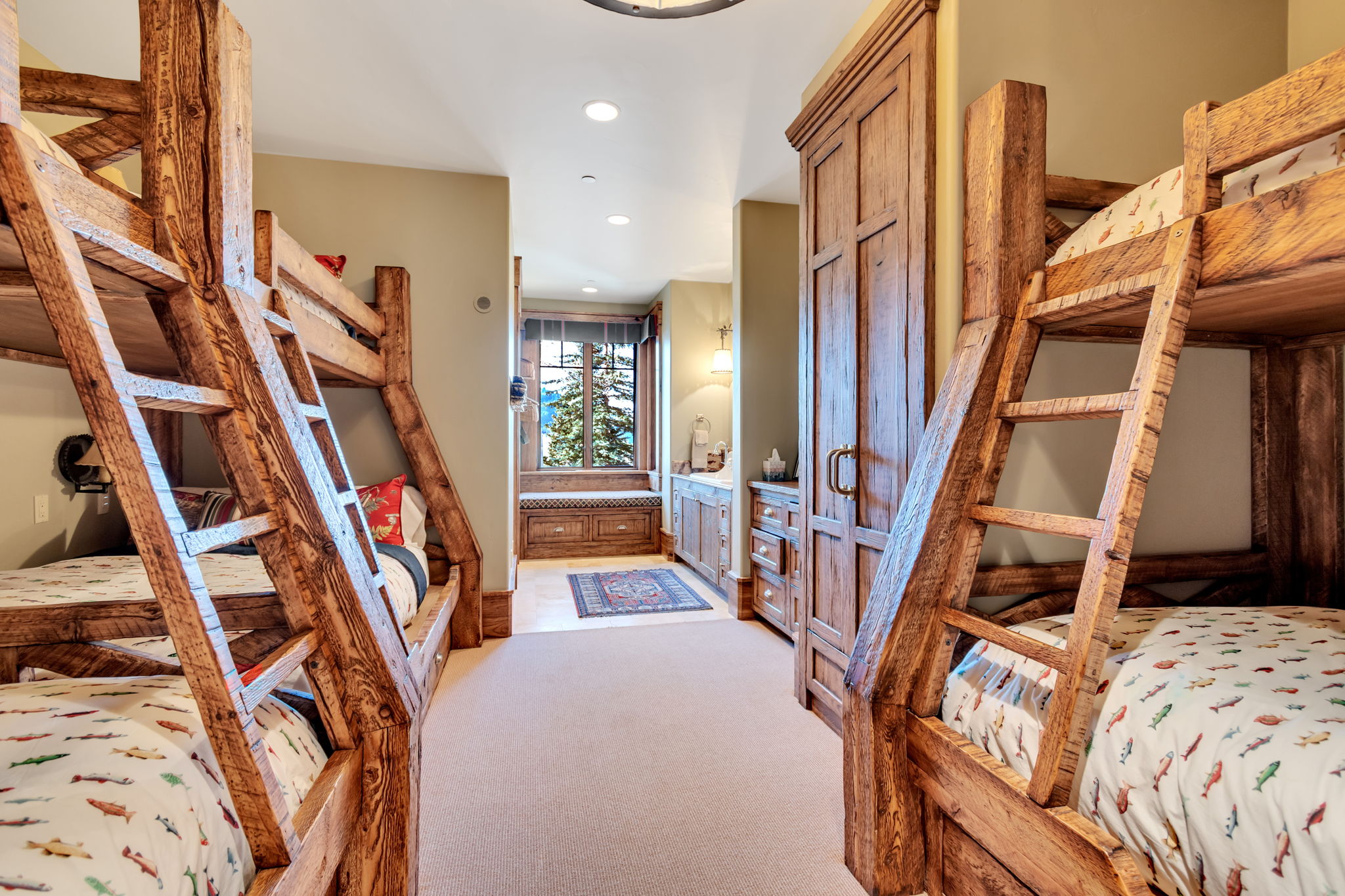 Room featuring two rustic wood-finish bunk beds, a built-in wood-finish wardrobe, and recessed lighting