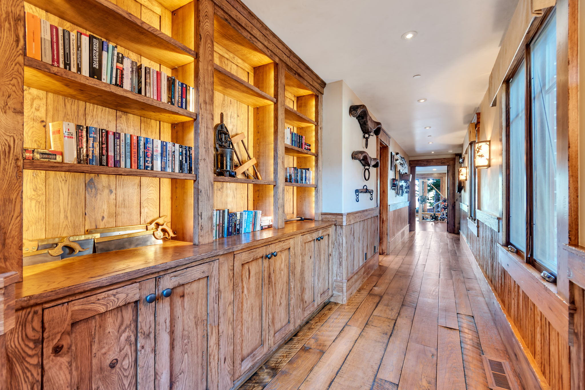 Hallway featuring extensive wood-finish flooring and paneling