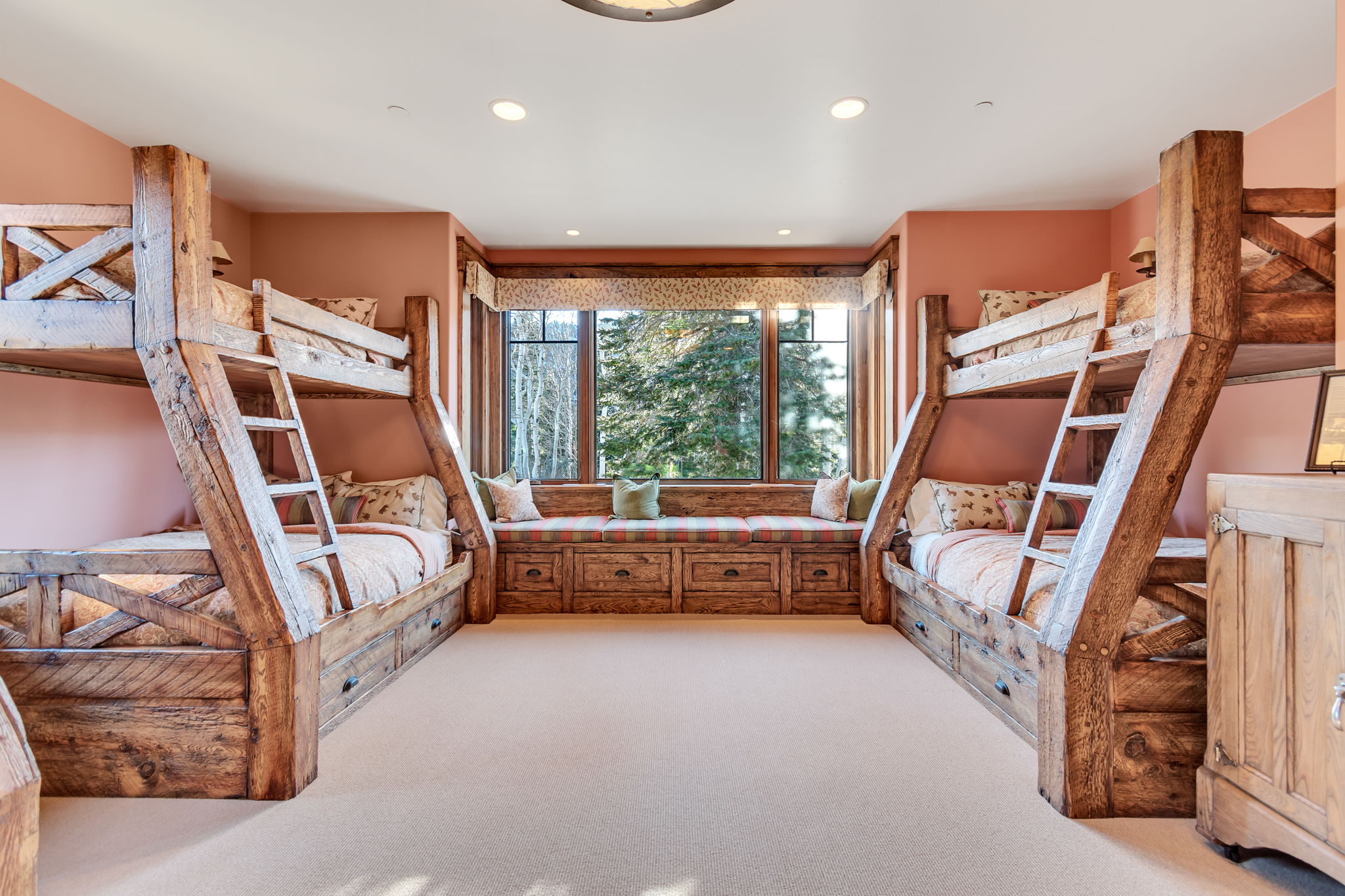 Room featuring two custom-built wooden bunk beds with integrated storage drawers